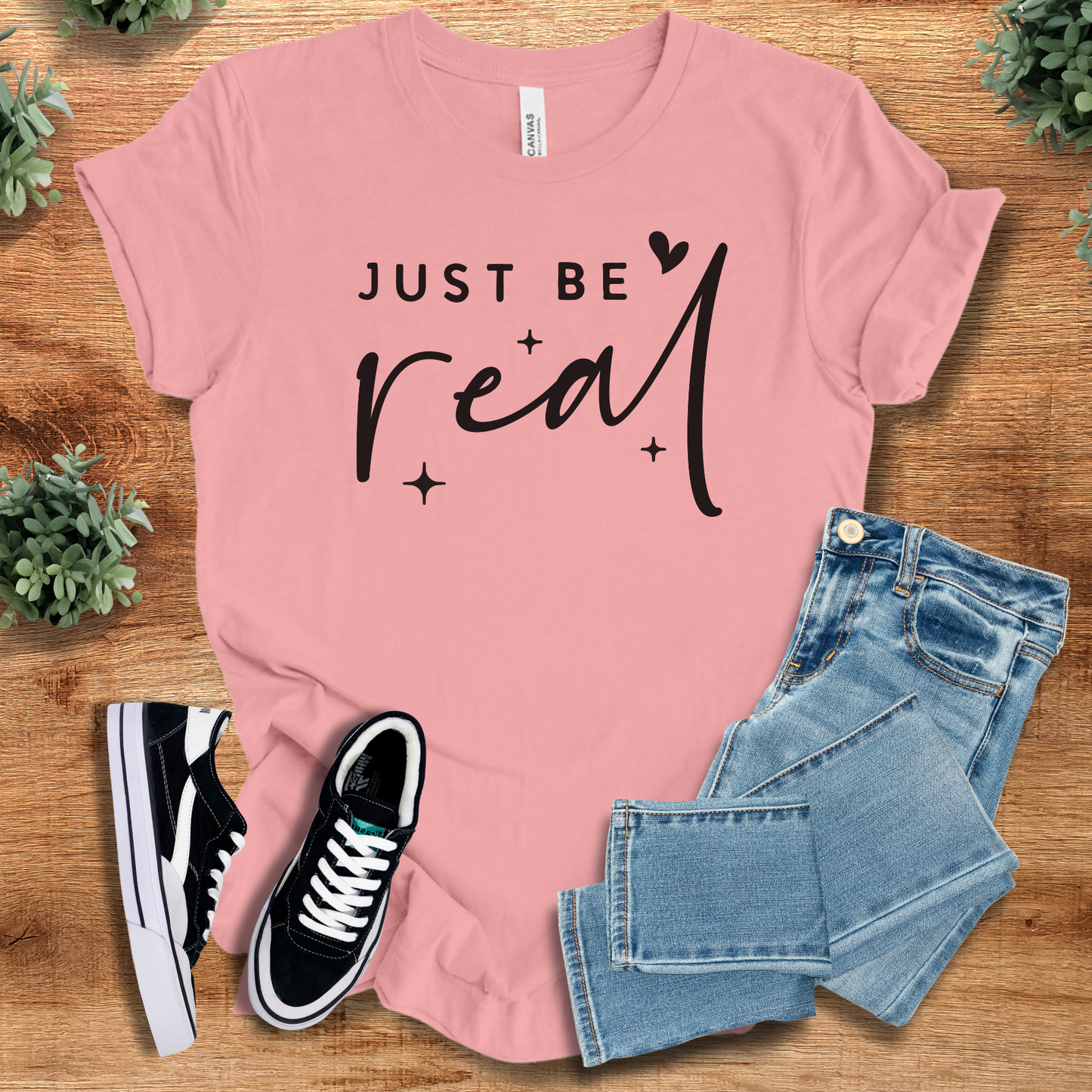 Heather-aqua t-shirt with '' text, flat lay styled on a wooden surface.