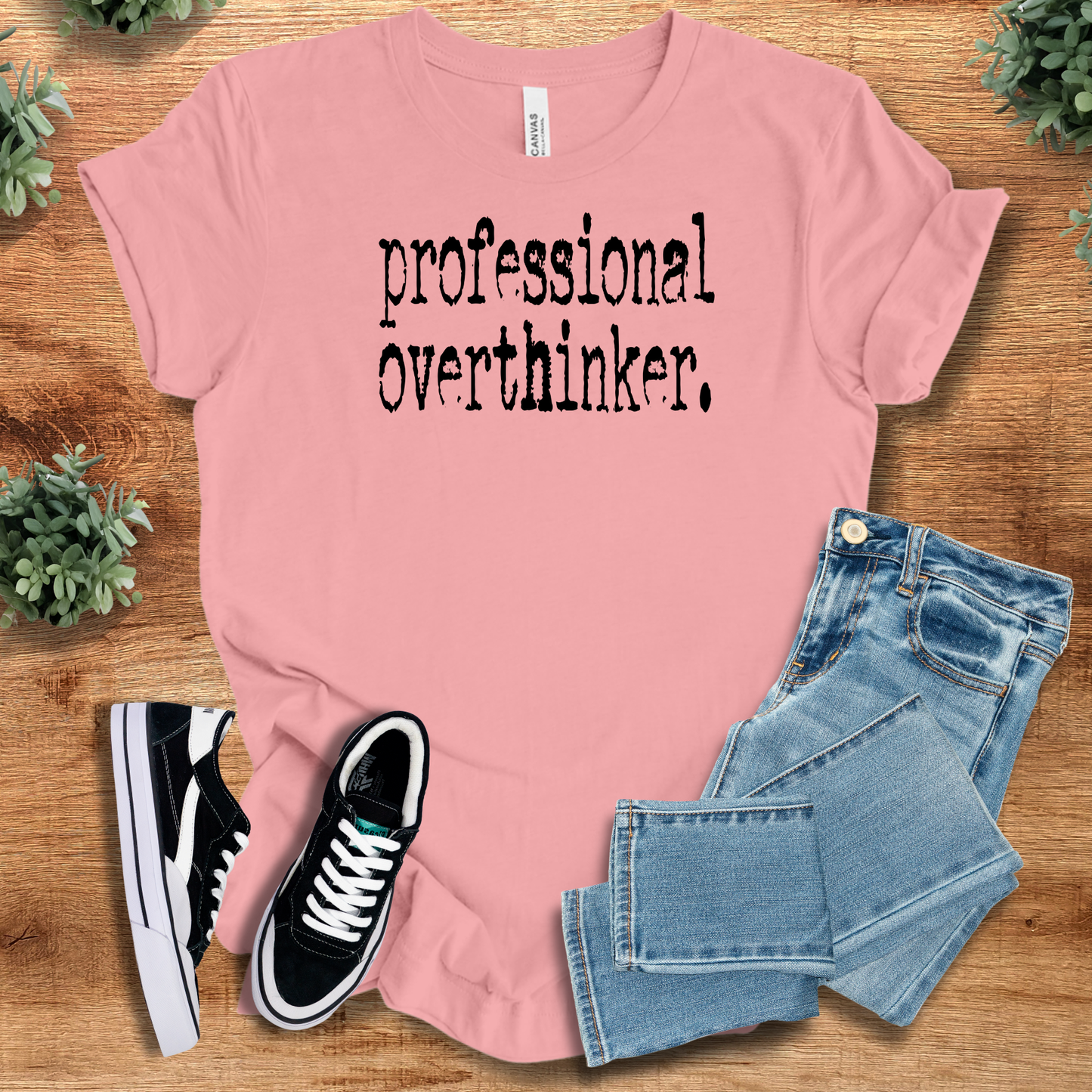 Athletic-heather t-shirt with '' text, flat lay styled on a wooden surface.