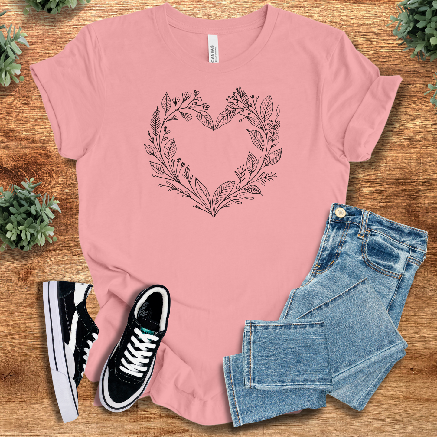 Athletic-heather t-shirt with '' text, flat lay styled on a wooden surface.