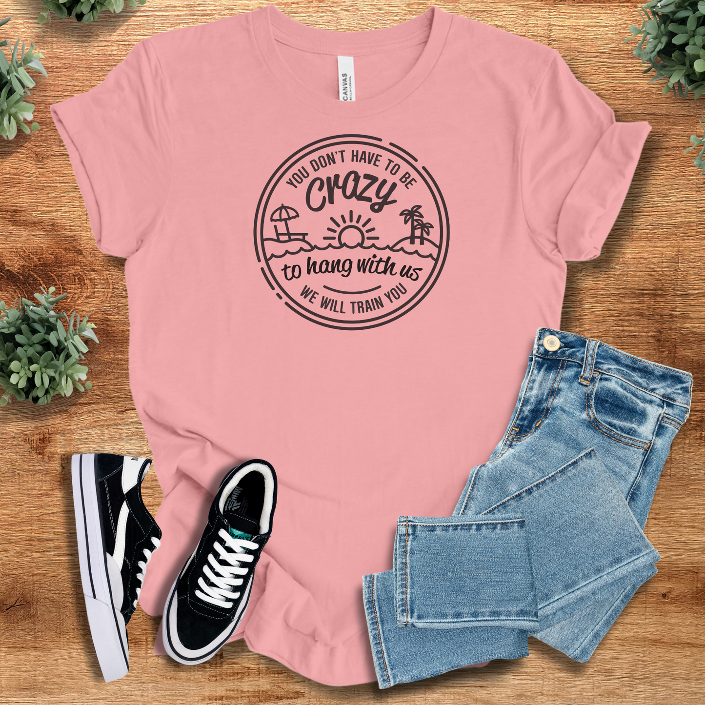 Soft pink graphic tee with humorous quote and beach illustration. A fun and stylish choice for group travel or casual wear.