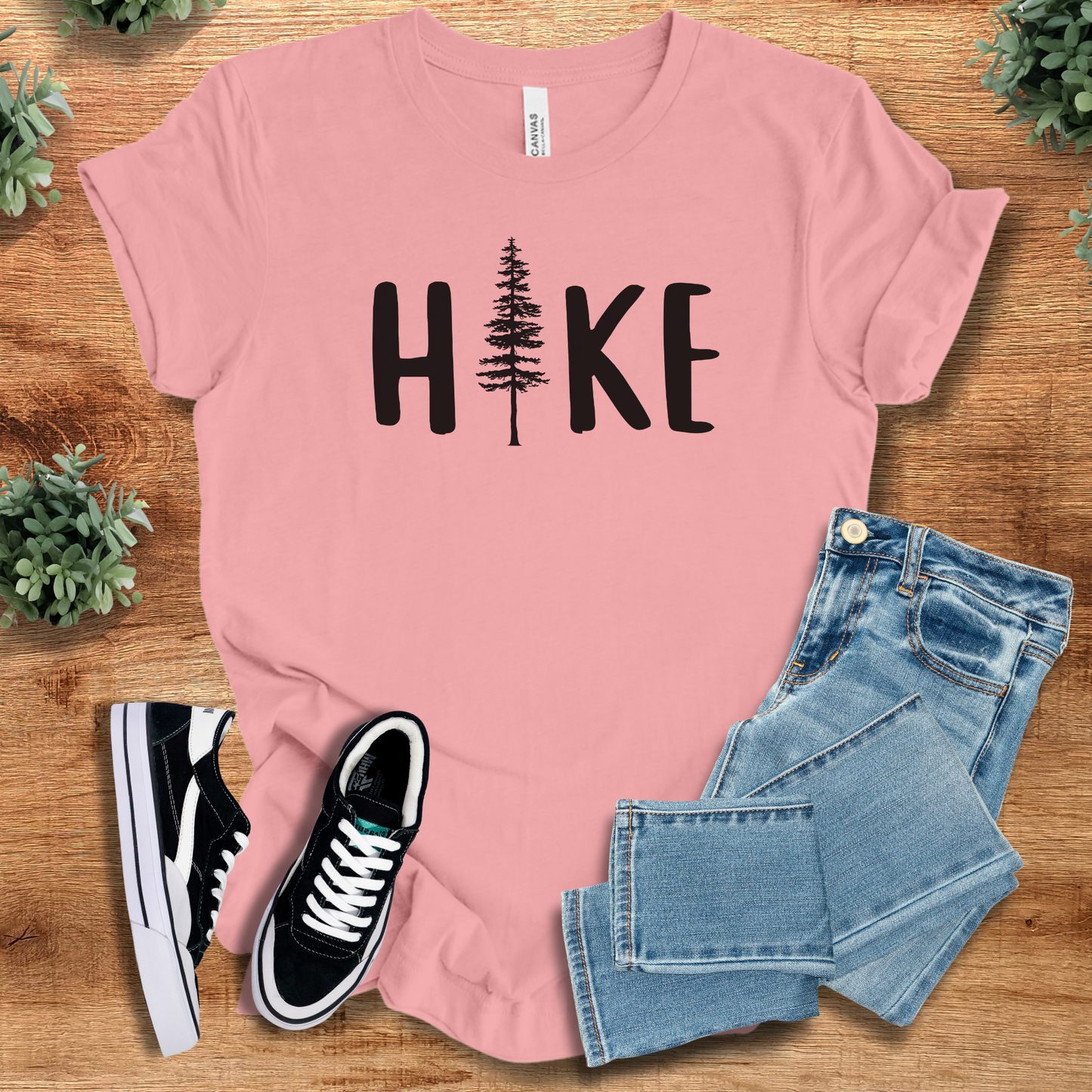 Hike T‑Shirt in light pink Bella+Canvas 3001 with black tree graphic. Soft unisex nature tee with minimalist hiking design.