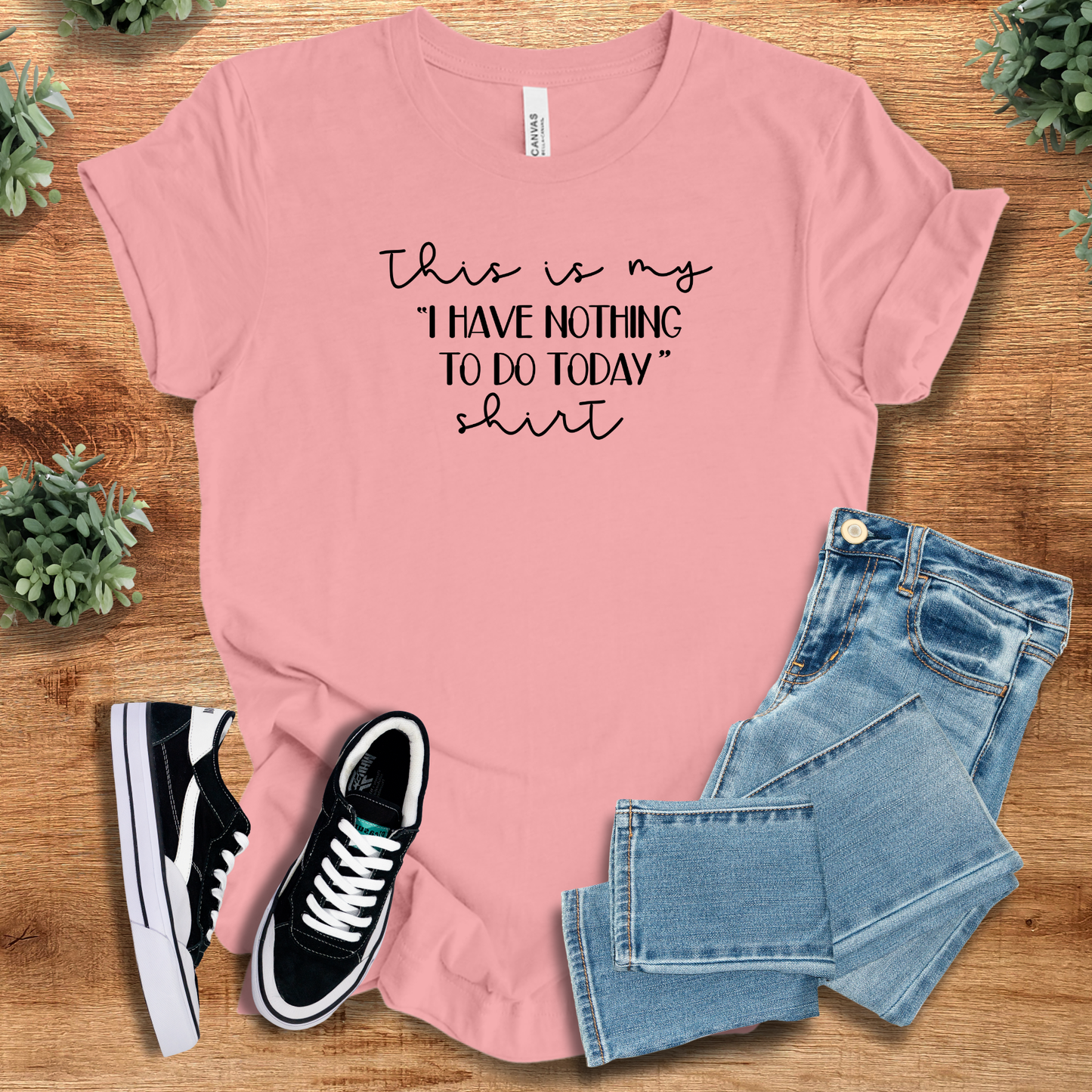 Athletic-heather t-shirt with '' text, flat lay styled on a wooden surface.