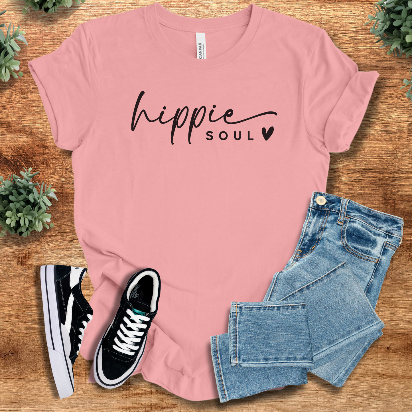 Heather-aqua t-shirt with '' text, flat lay styled on a wooden surface.