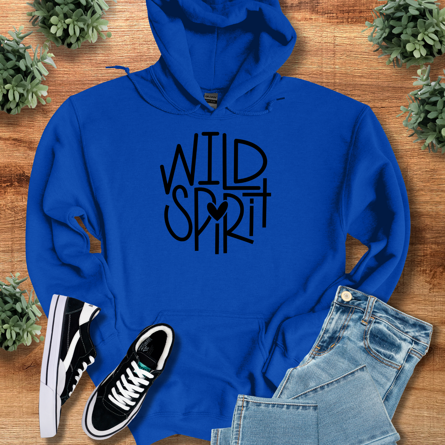 Wild Spirit Hoodie for Outdoor and Casual Wear in royal blue with bold black lettering, styled with jeans and sneakers for a cozy, unisex look.