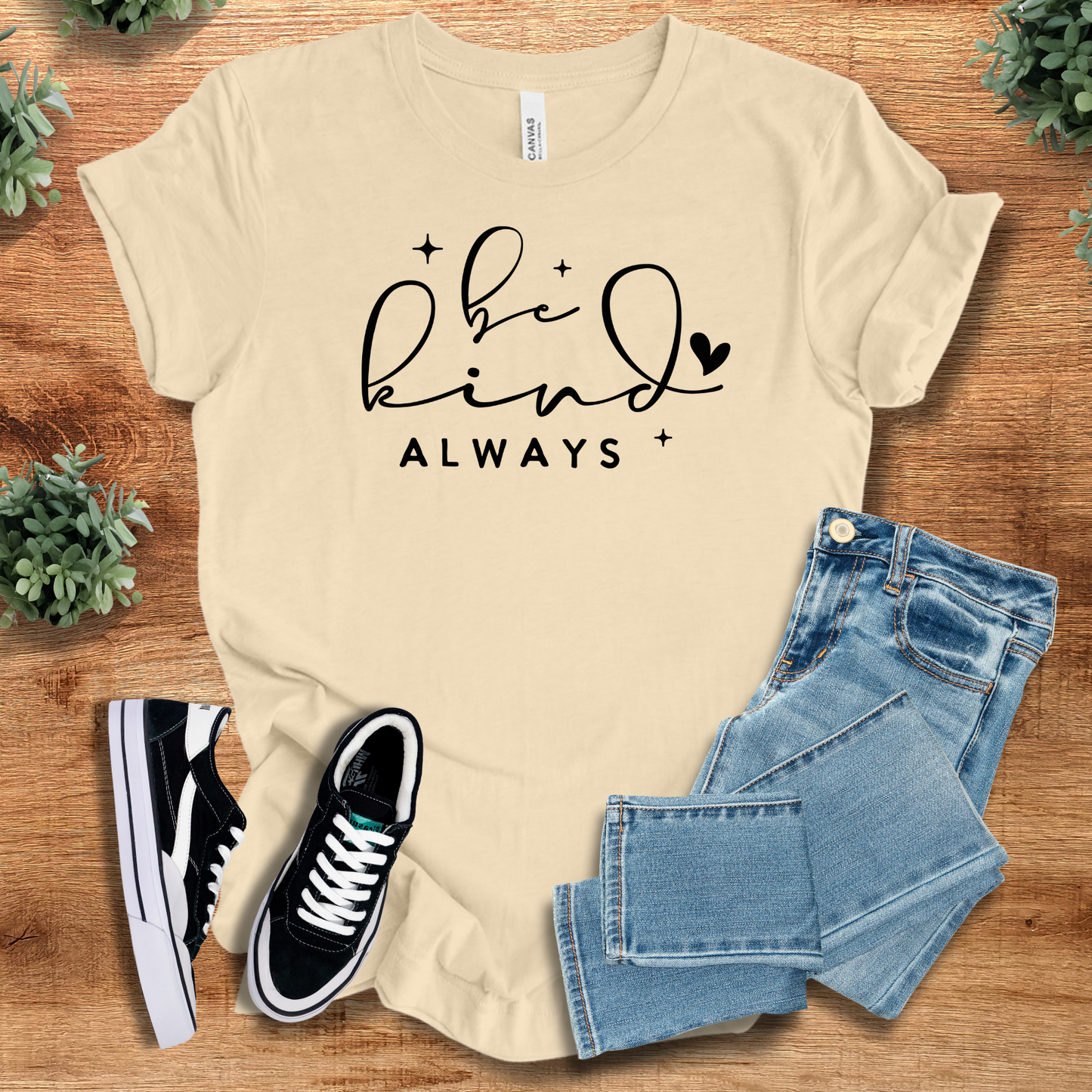 Heather-aqua t-shirt with '' text, flat lay styled on a wooden surface.