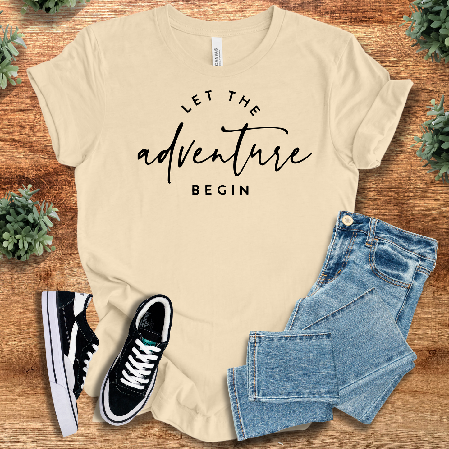 Athletic-heather t-shirt with '' text, flat lay styled on a wooden surface.