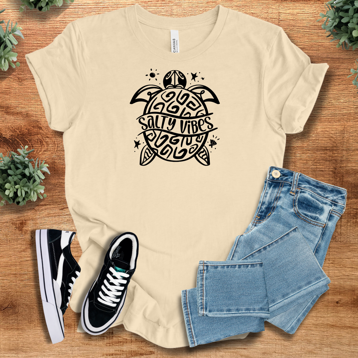 Athletic-heather t-shirt with '' text, flat lay styled on a wooden surface.