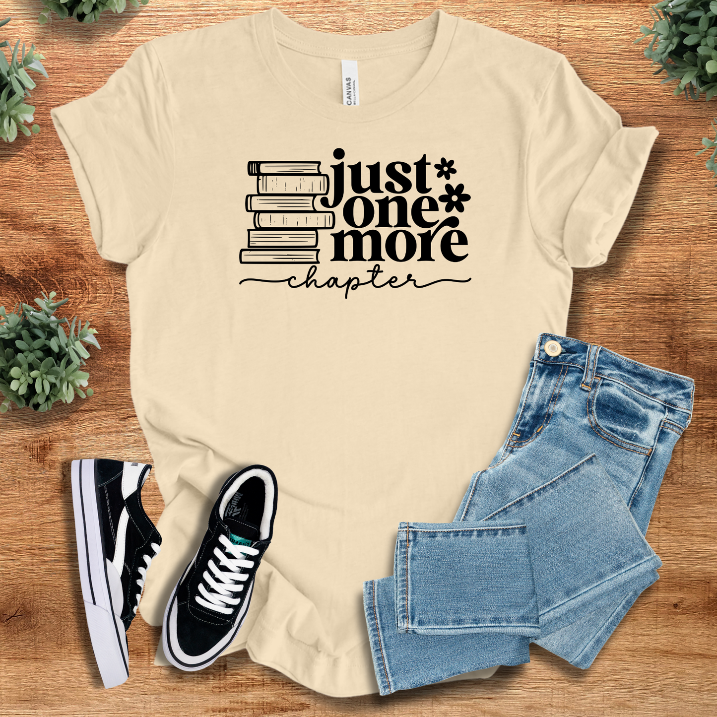 Cream beige 'Just One More Chapter' cozy tee for literature lovers. Unisex cotton shirt styled with jeans and sneakers.