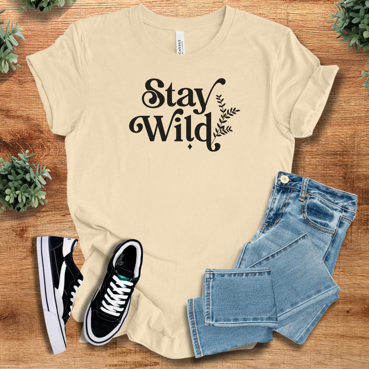 Heather-mauve t-shirt with '' text, flat lay styled on a wooden surface.