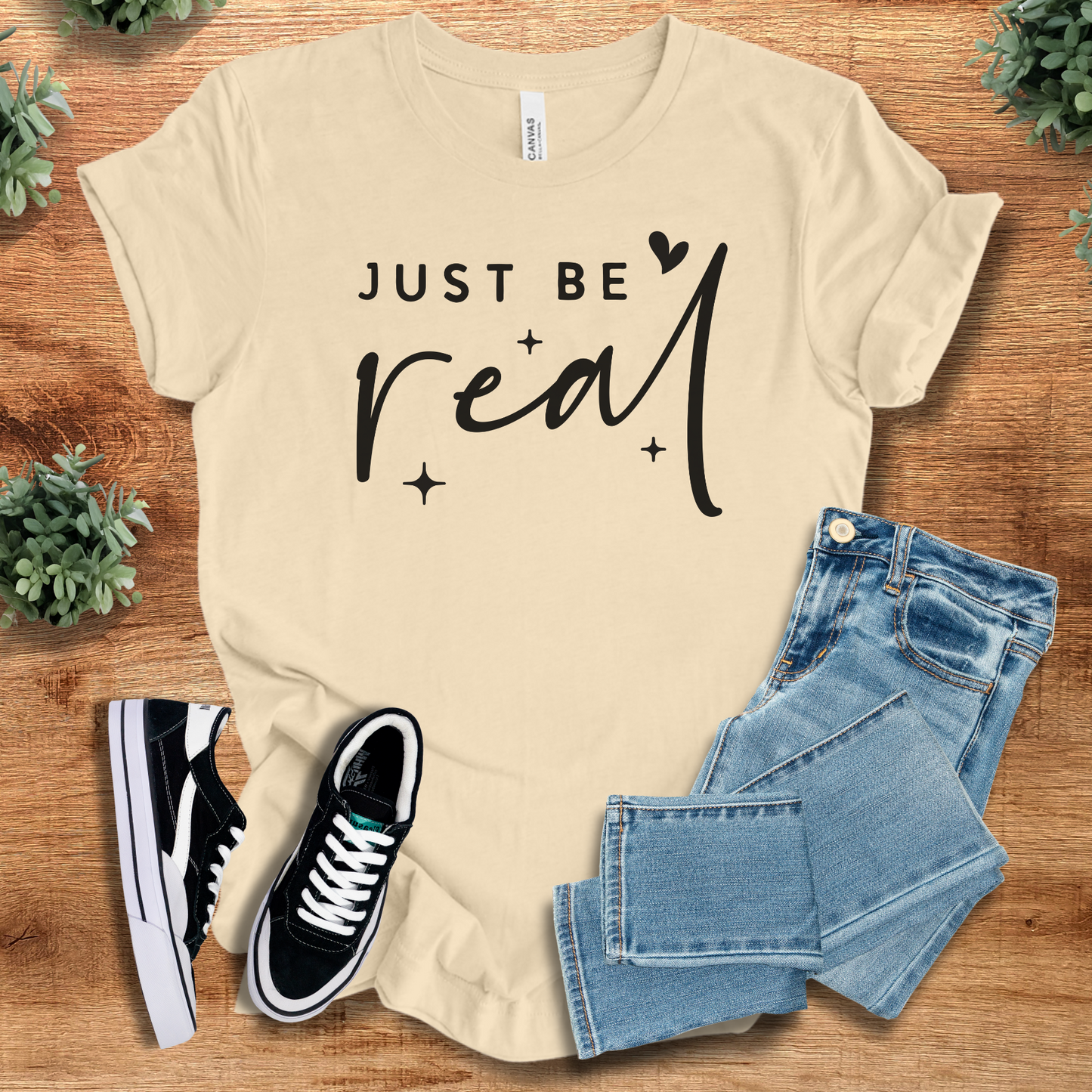 Athletic-heather t-shirt with '' text, flat lay styled on a wooden surface.