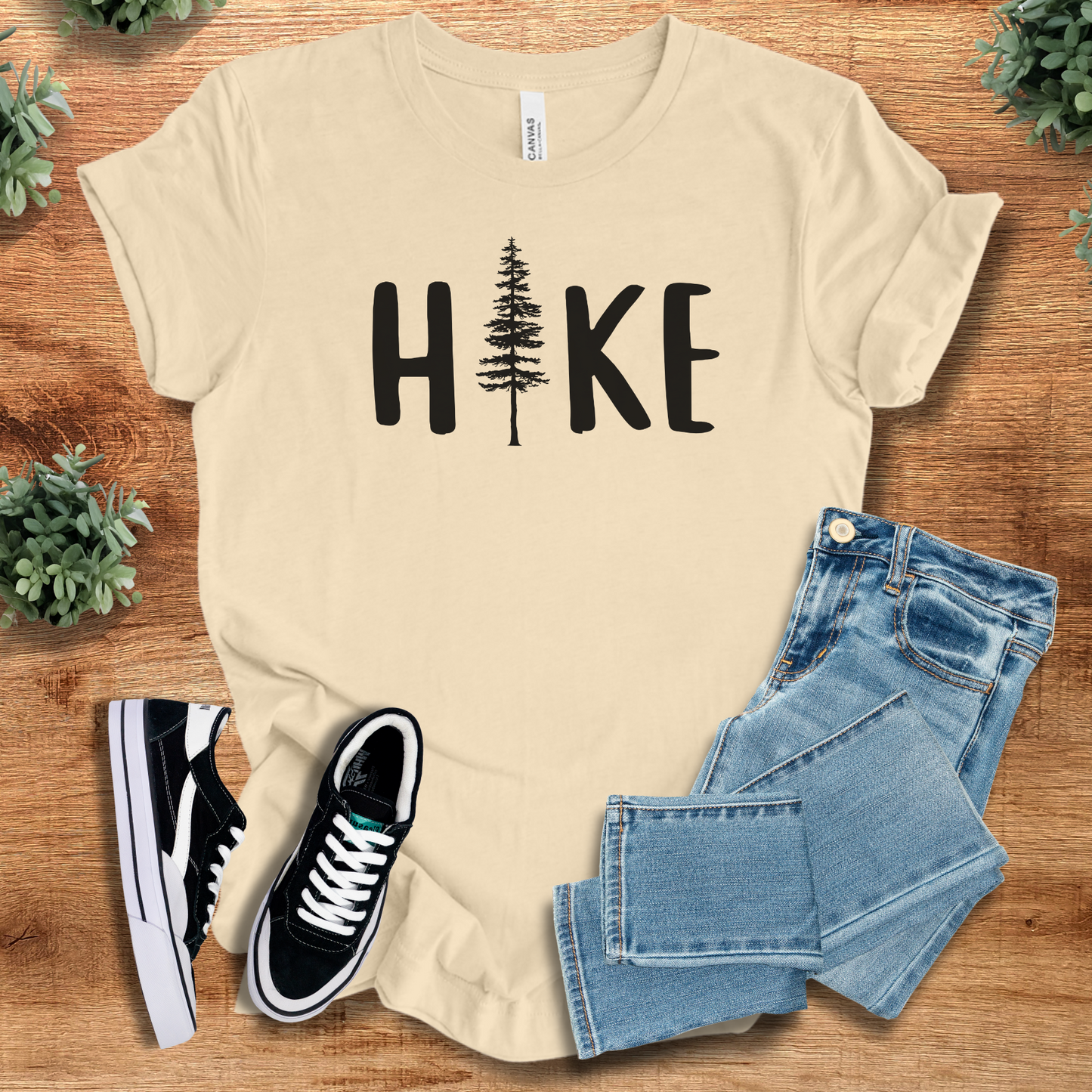 Hike T‑Shirt in cream Bella+Canvas 3001 with black tree design. Buttery-soft unisex minimalist tee for outdoor enthusiasts.