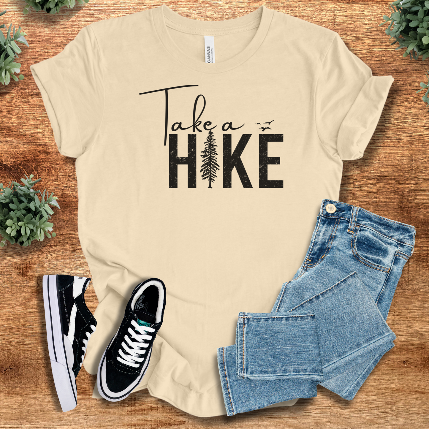 Heather-mauve t-shirt with '' text, flat lay styled on a wooden surface.
