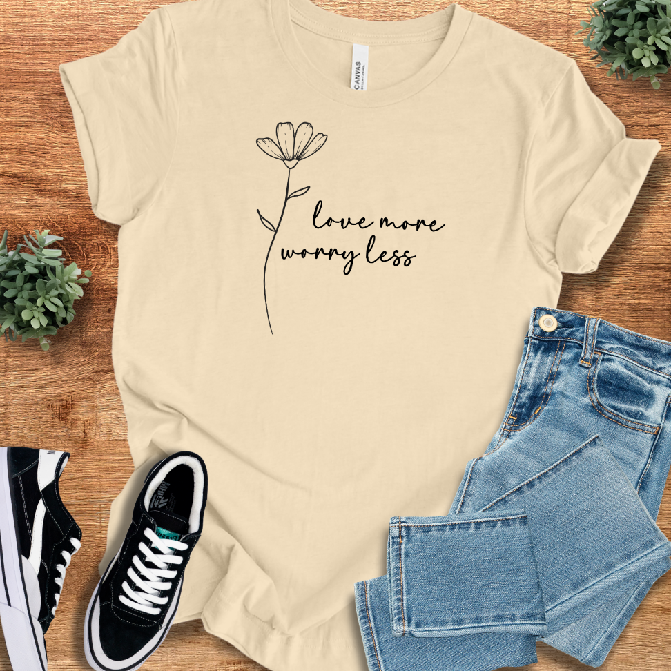 Heather-mauve t-shirt with '' text, flat lay styled on a wooden surface.