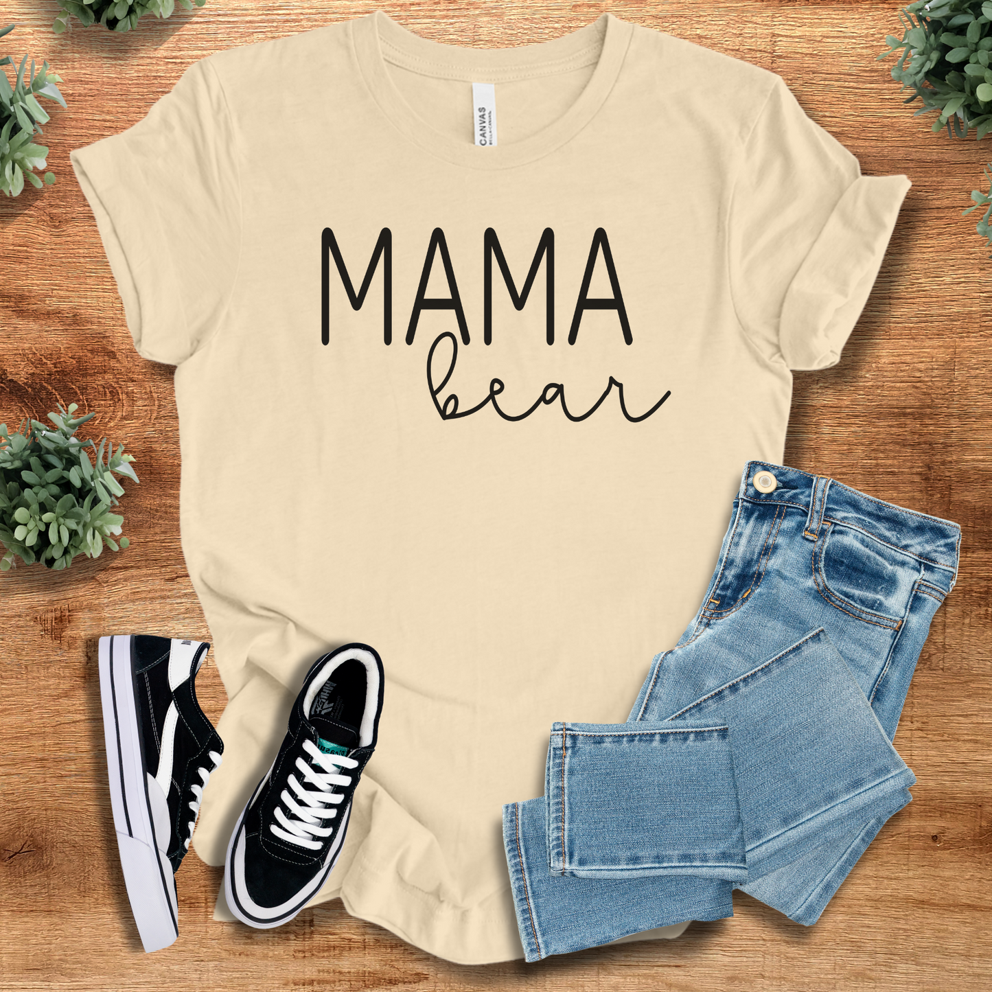 Heather-navy t-shirt with '' text, flat lay styled on a wooden surface.