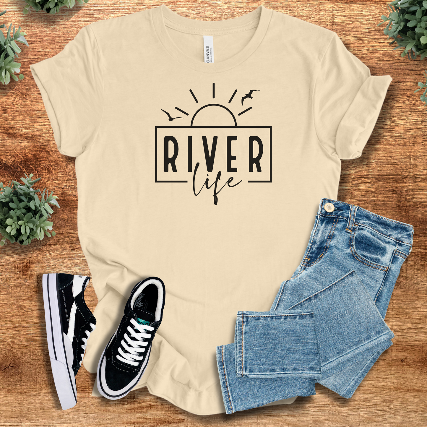 Heather-mauve t-shirt with '' text, flat lay styled on a wooden surface.