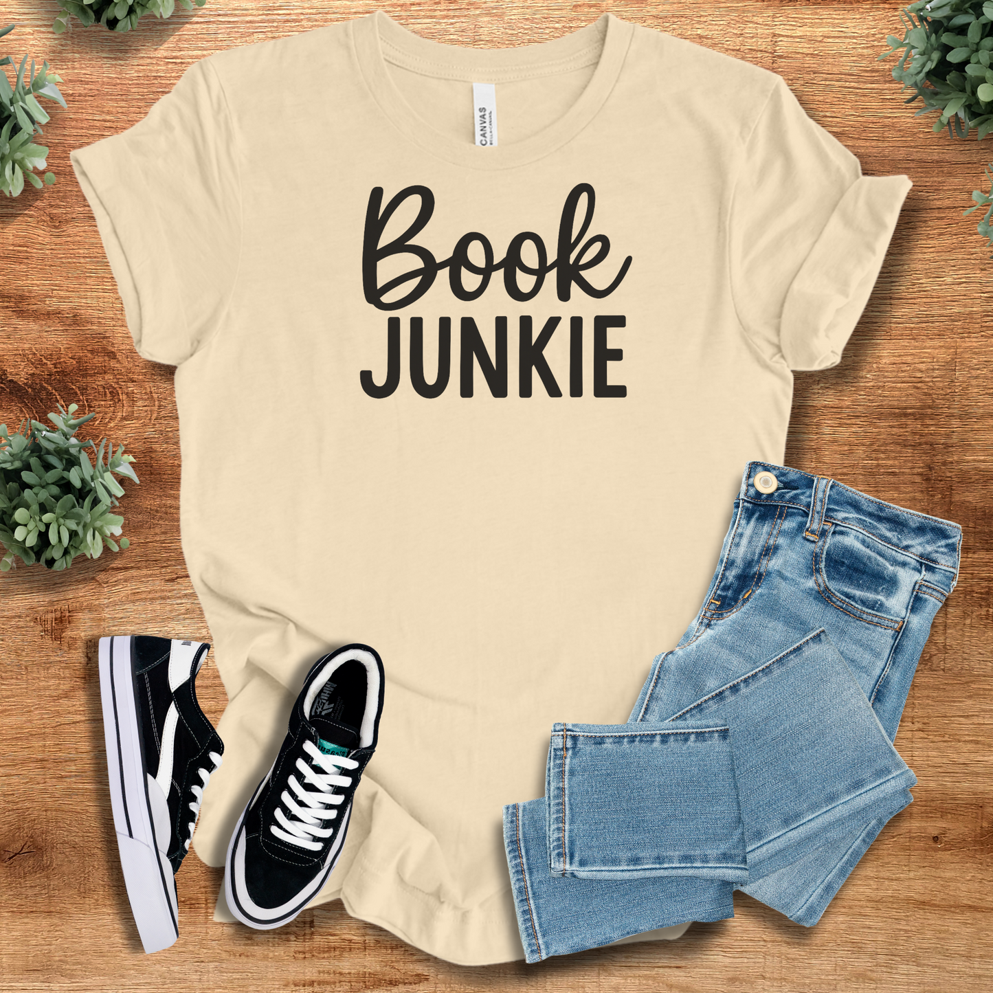 Athletic-heather t-shirt with '' text, flat lay styled on a wooden surface.