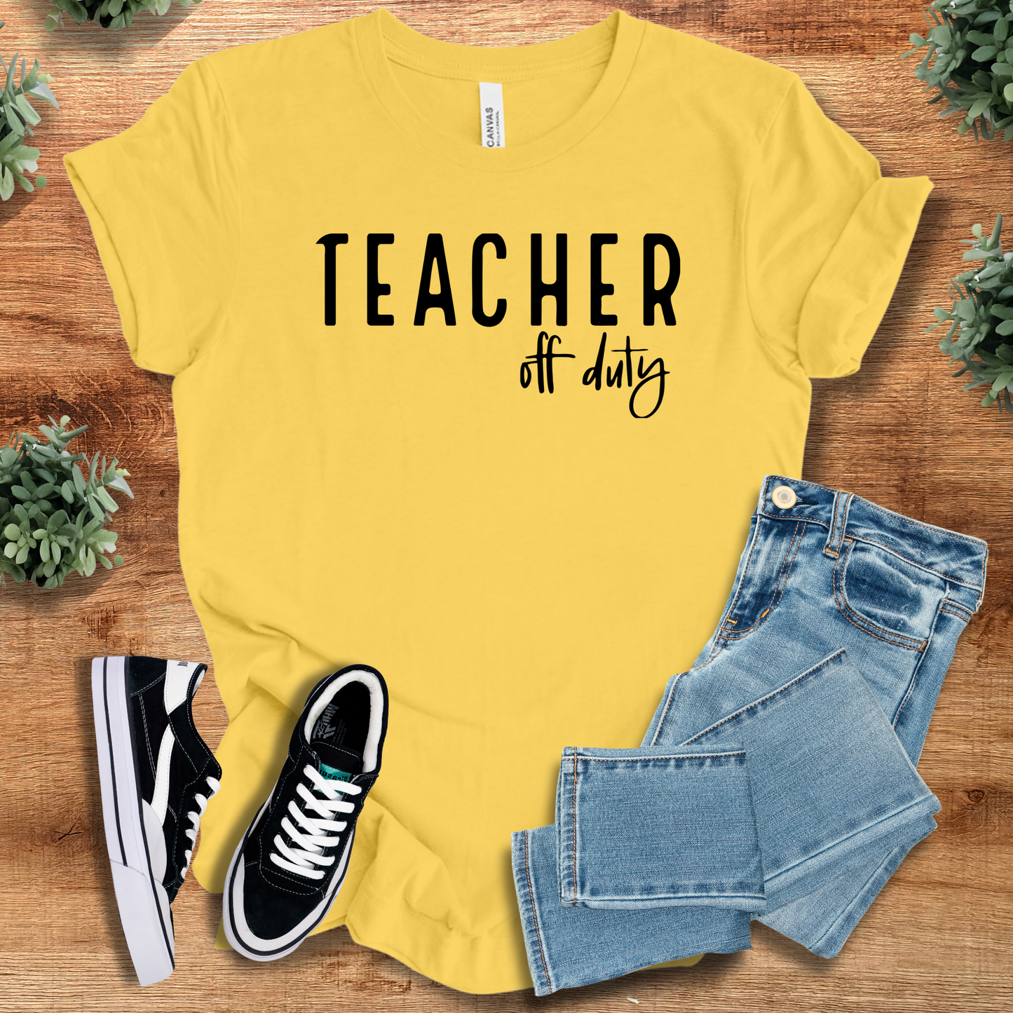 Athletic-heather t-shirt with '' text, flat lay styled on a wooden surface.