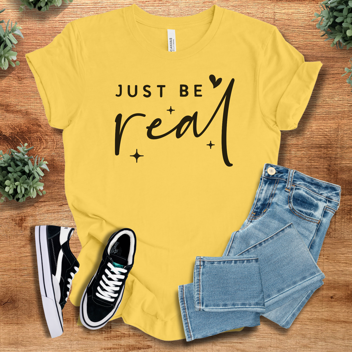 Athletic-heather t-shirt with '' text, flat lay styled on a wooden surface.