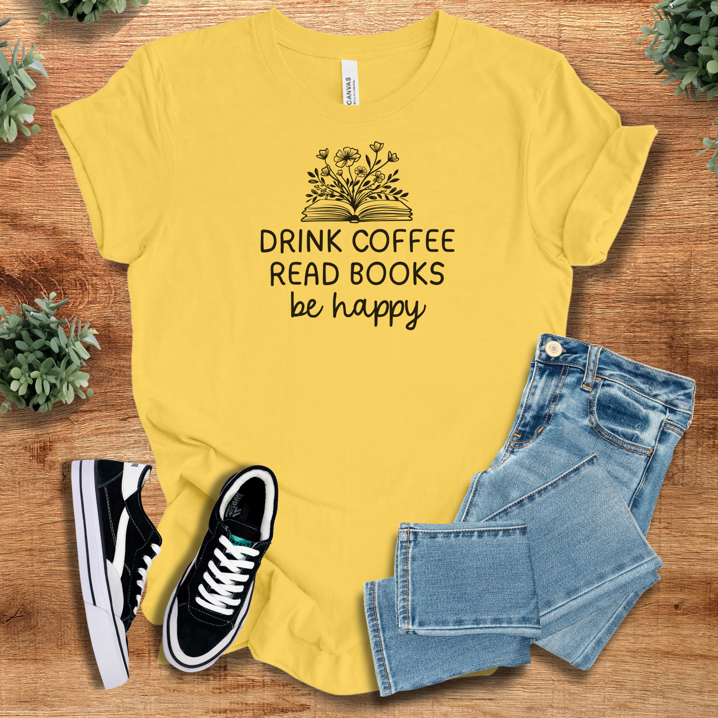 Heather-navy t-shirt with '' text, flat lay styled on a wooden surface.