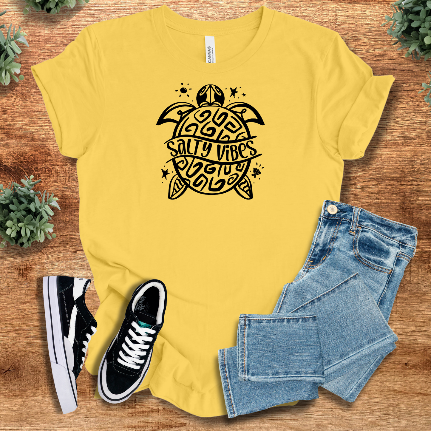Athletic-heather t-shirt with '' text, flat lay styled on a wooden surface.