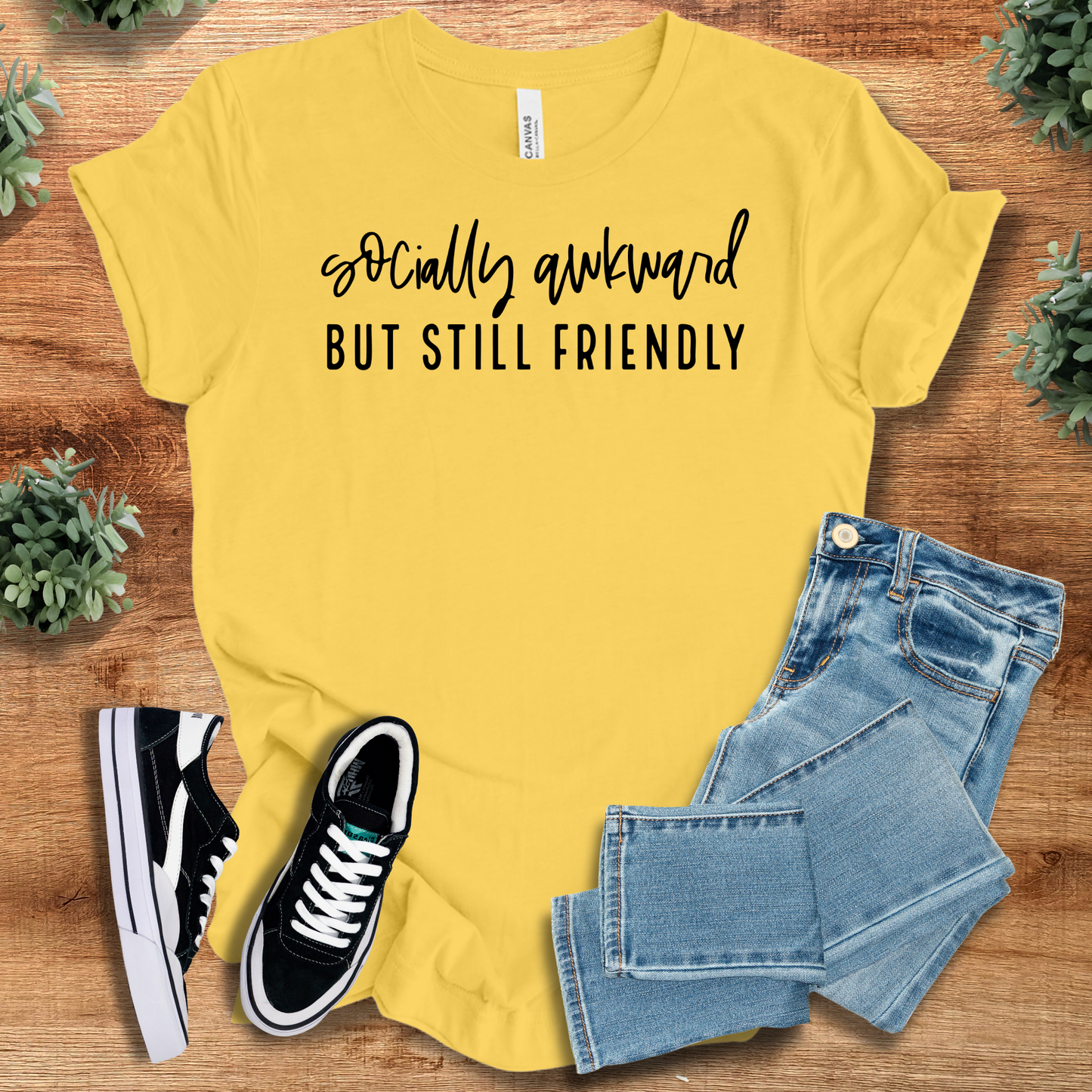 Athletic-heather t-shirt with '' text, flat lay styled on a wooden surface.