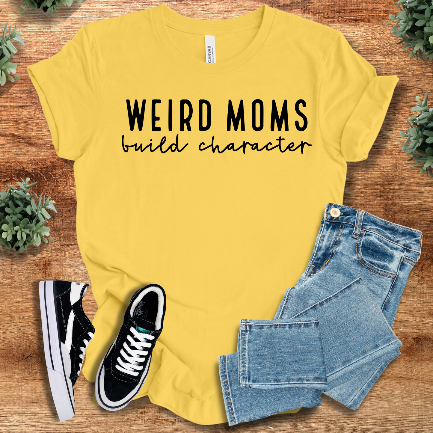 Athletic-heather t-shirt with '' text, flat lay styled on a wooden surface.