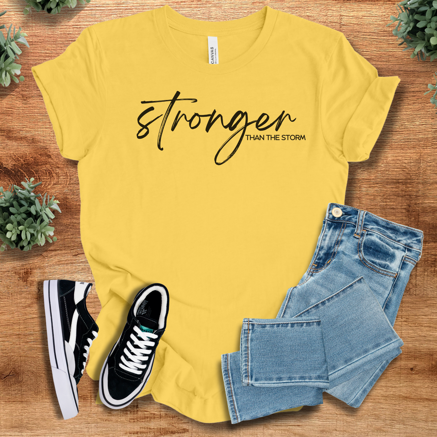 Heather-mauve t-shirt with '' text, flat lay styled on a wooden surface.