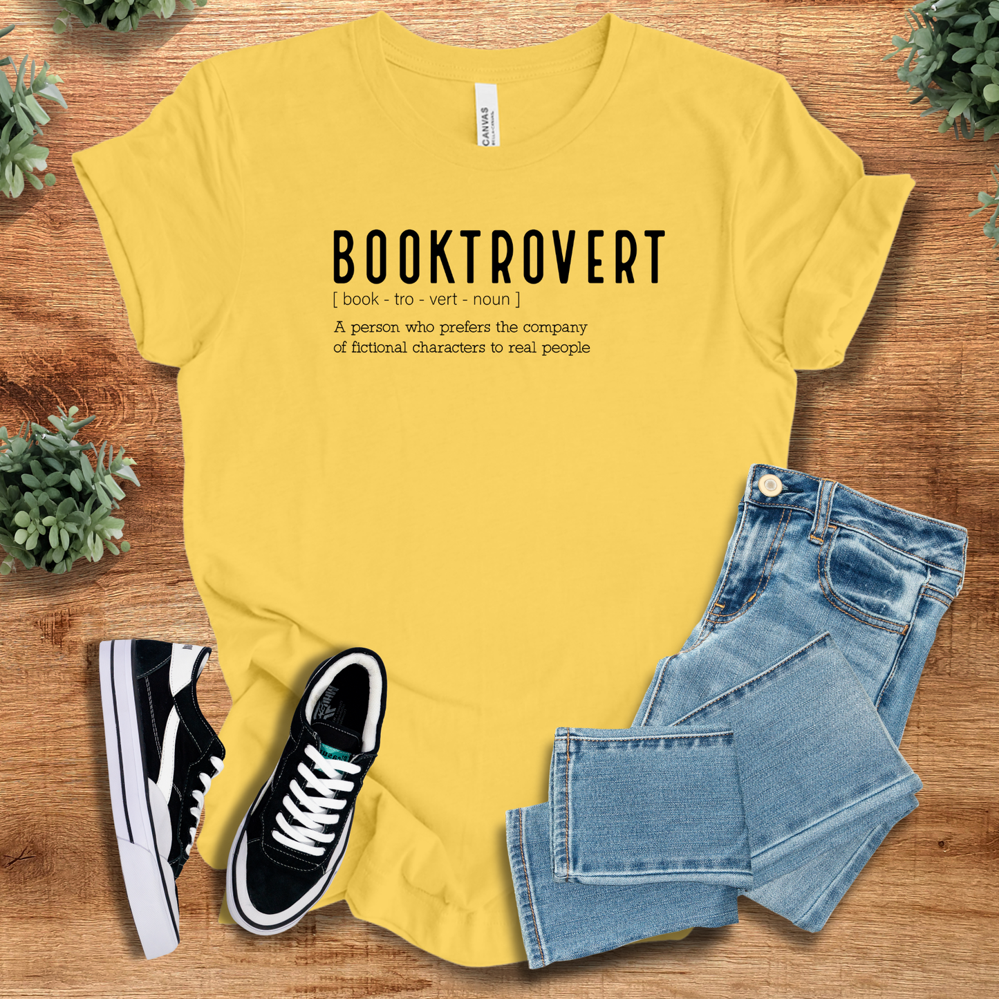 Athletic-heather t-shirt with '' text, flat lay styled on a wooden surface.