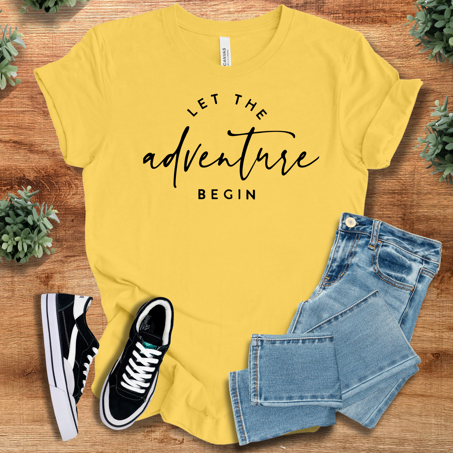 Athletic-heather t-shirt with '' text, flat lay styled on a wooden surface.