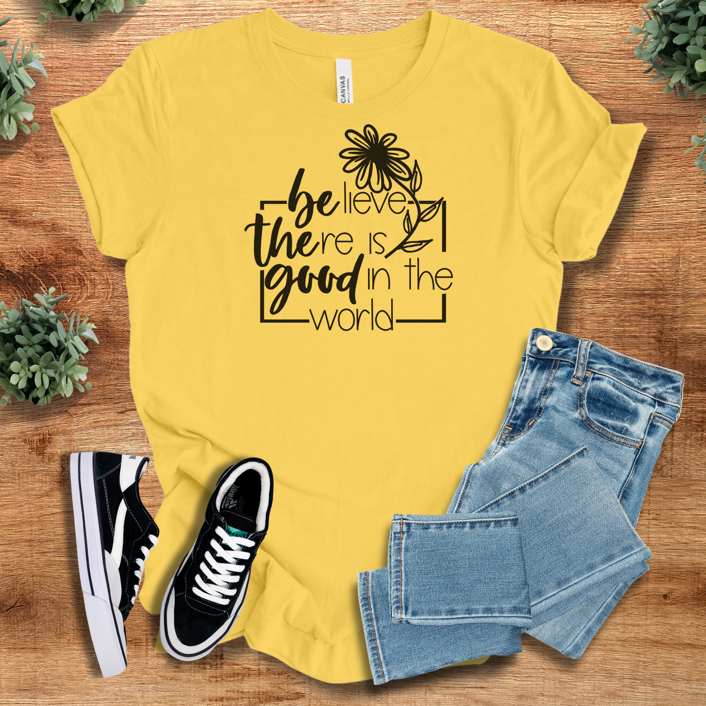 Athletic-heather t-shirt with '' text, flat lay styled on a wooden surface.