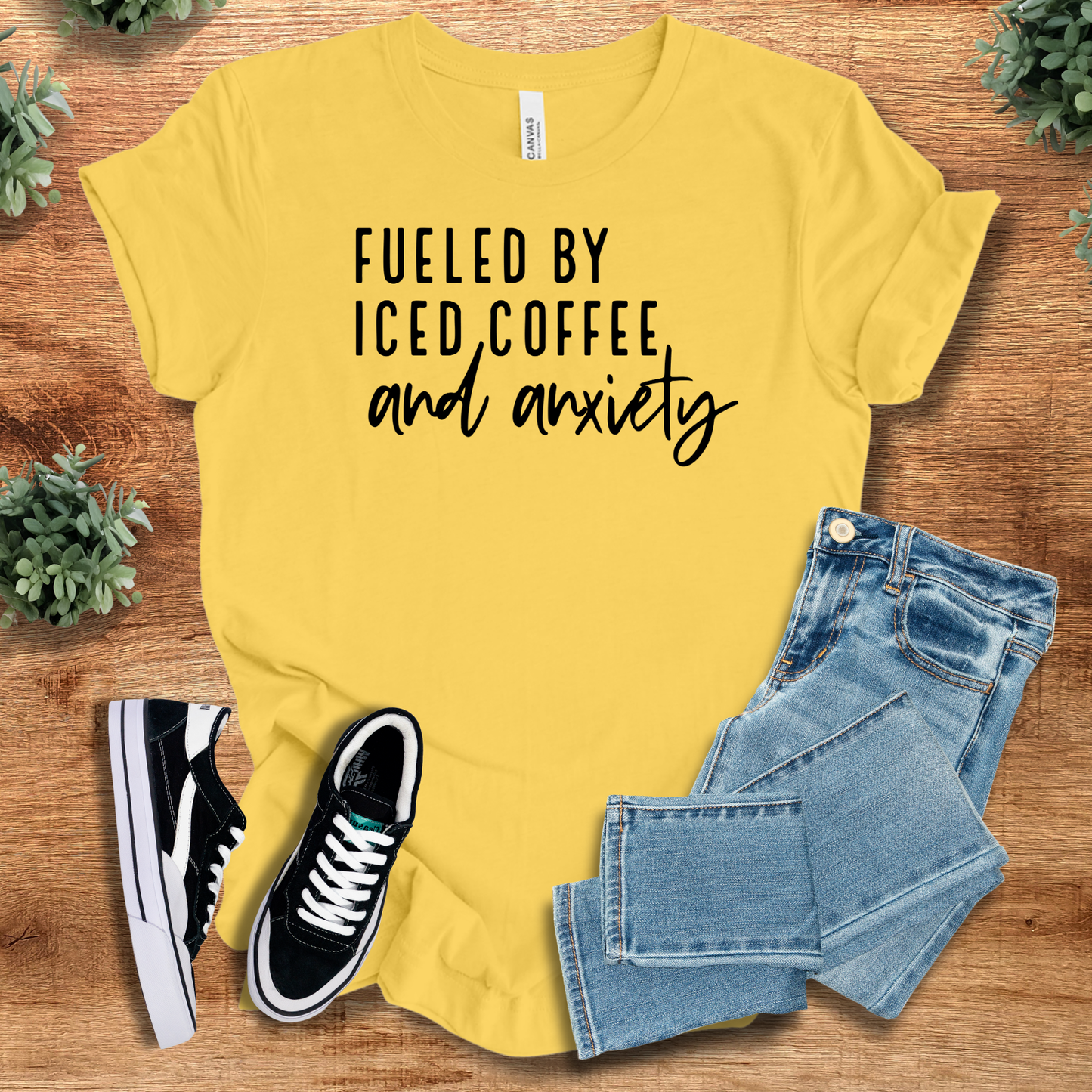 Athletic-heather t-shirt with '' text, flat lay styled on a wooden surface.