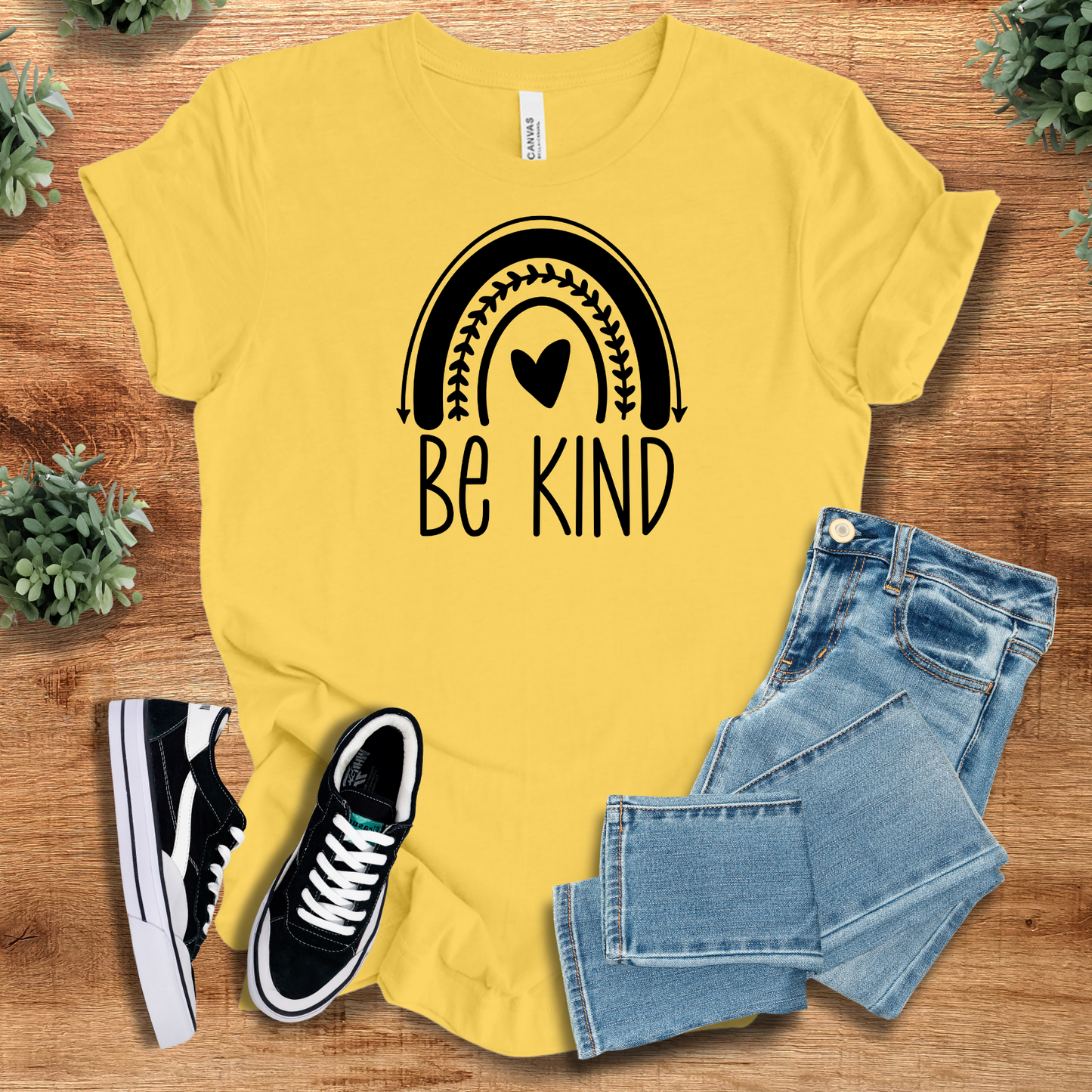 Heather-navy t-shirt with '' text, flat lay styled on a wooden surface.