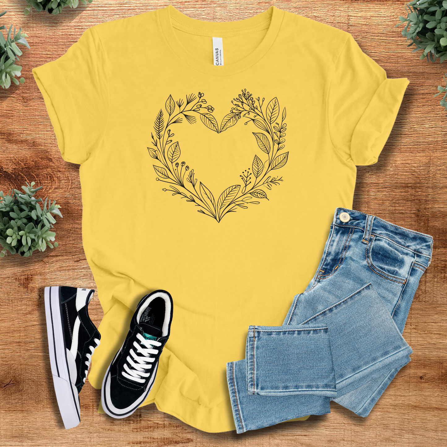Athletic-heather t-shirt with '' text, flat lay styled on a wooden surface.