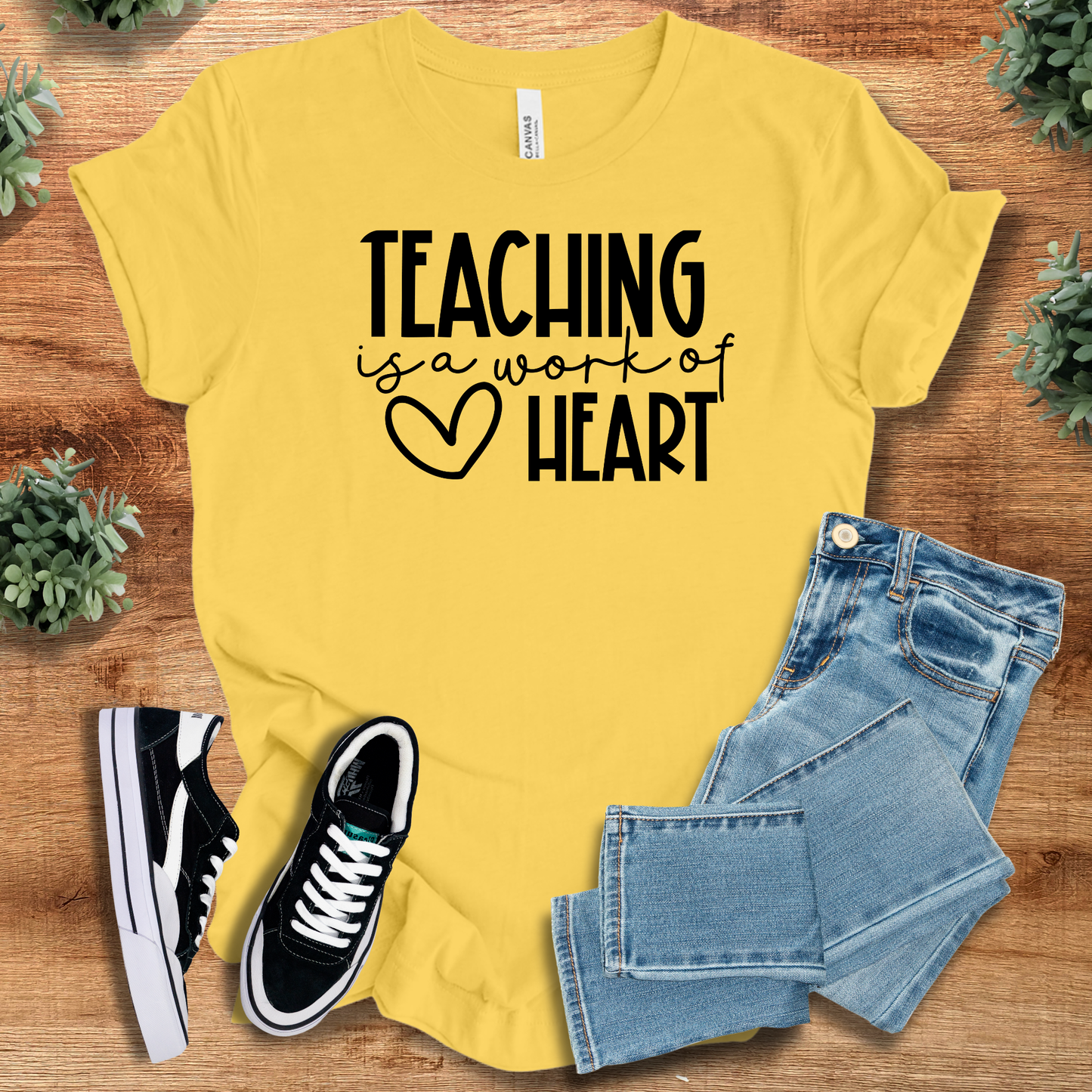 Athletic-heather t-shirt with '' text, flat lay styled on a wooden surface.