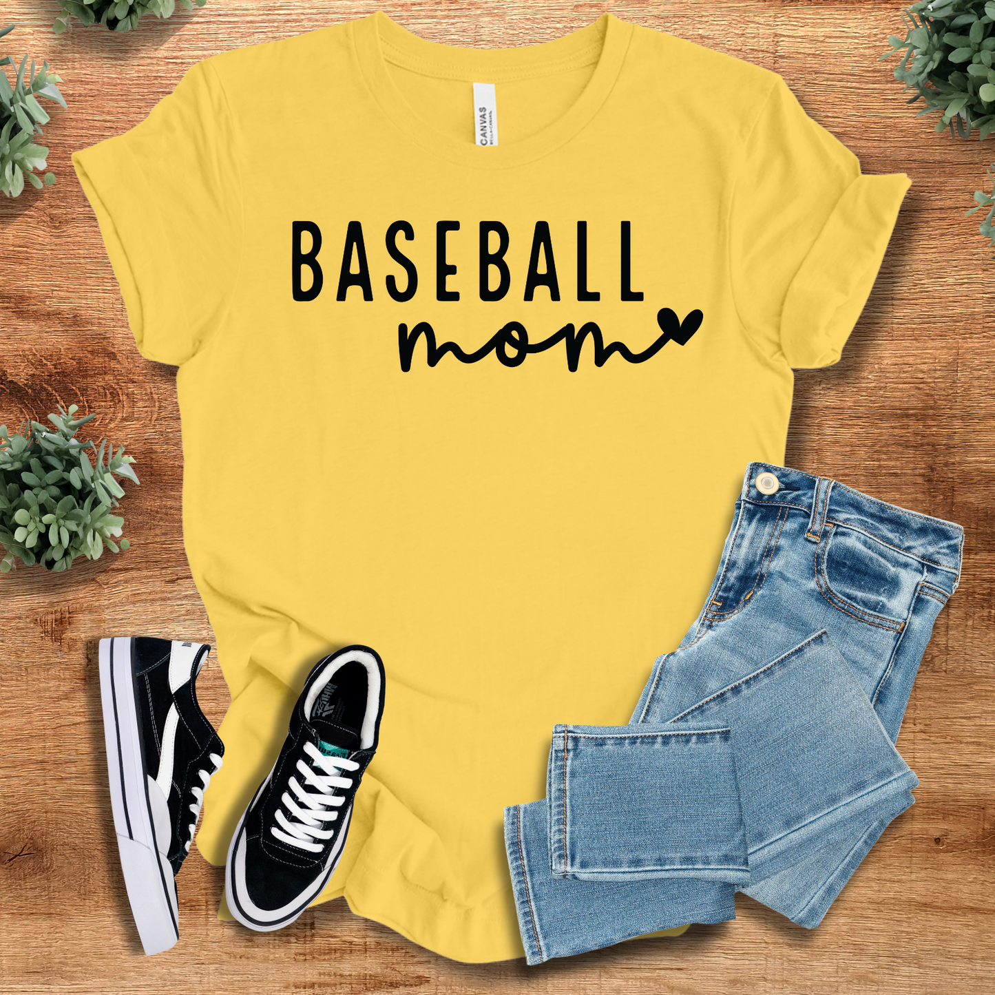 Athletic-heather t-shirt with '' text, flat lay styled on a wooden surface.