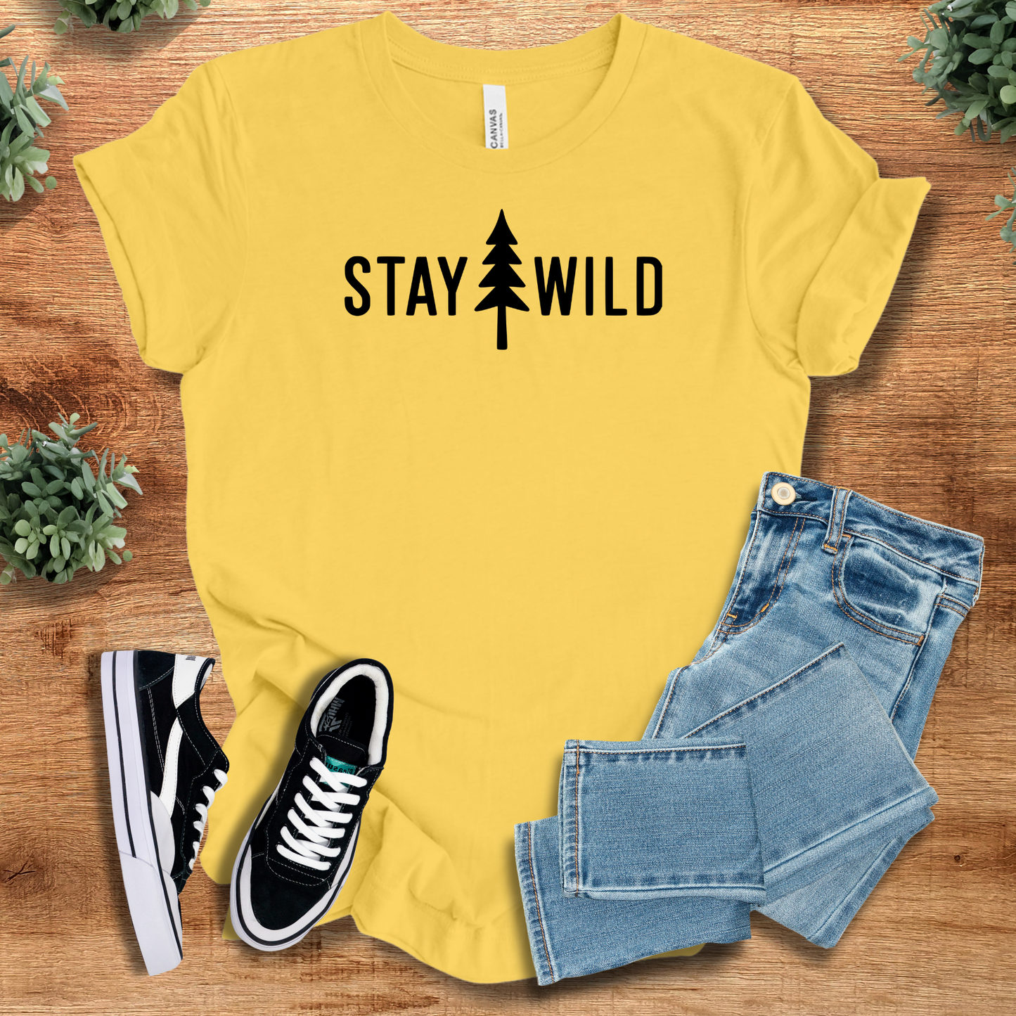 Athletic-heather t-shirt with '' text, flat lay styled on a wooden surface.