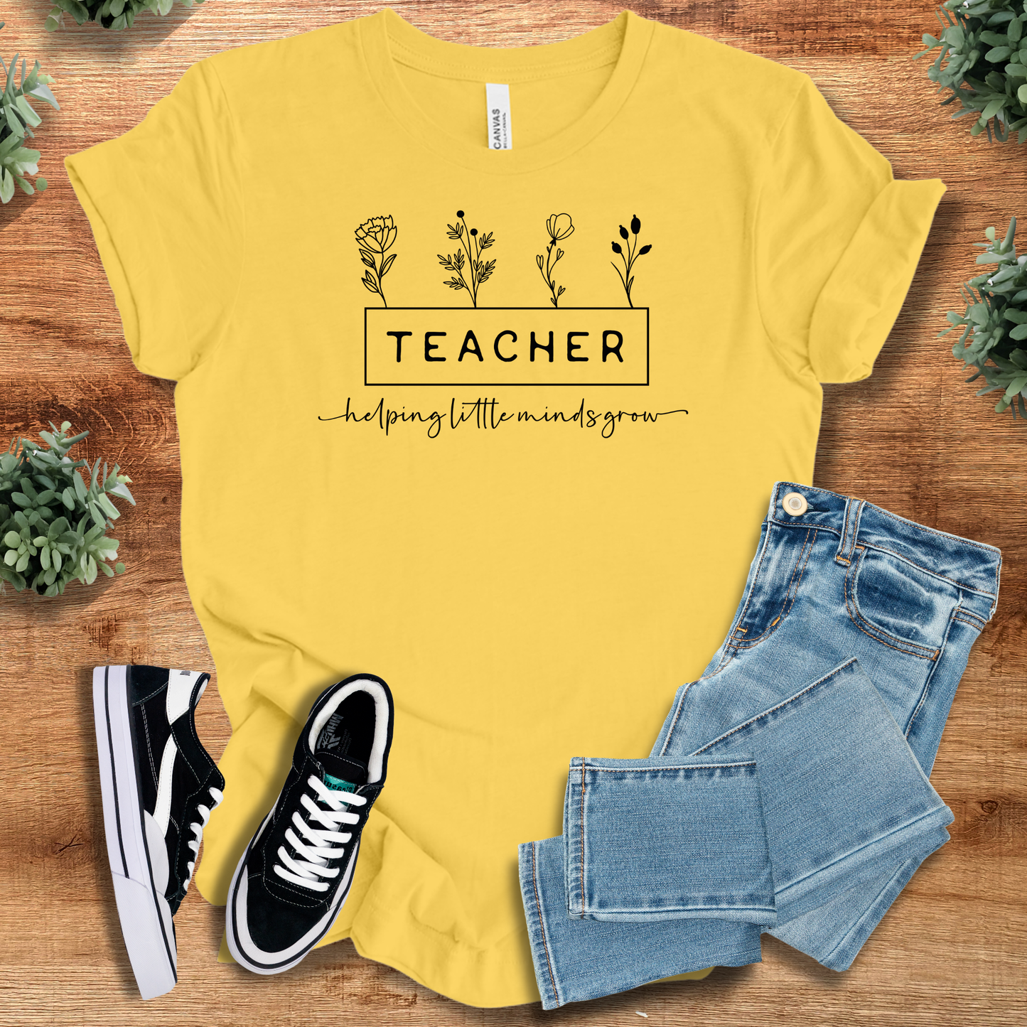 Athletic-heather t-shirt with '' text, flat lay styled on a wooden surface.