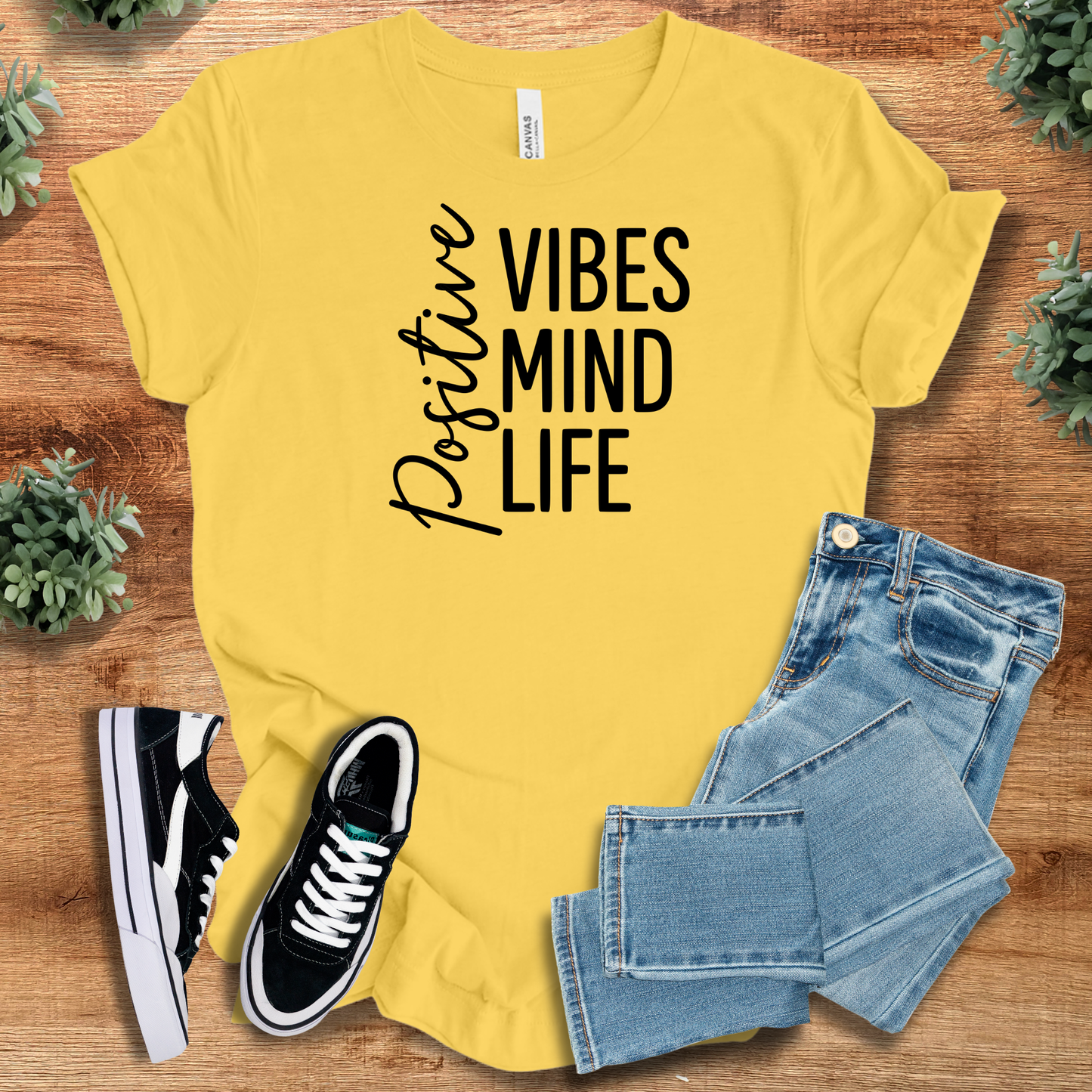 Athletic-heather t-shirt with '' text, flat lay styled on a wooden surface.