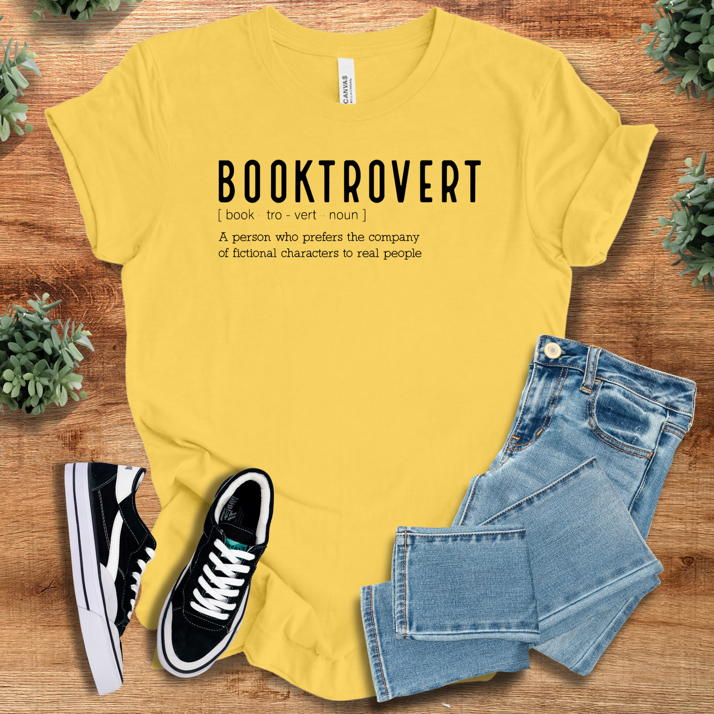 Athletic-heather t-shirt with '' text, flat lay styled on a wooden surface.