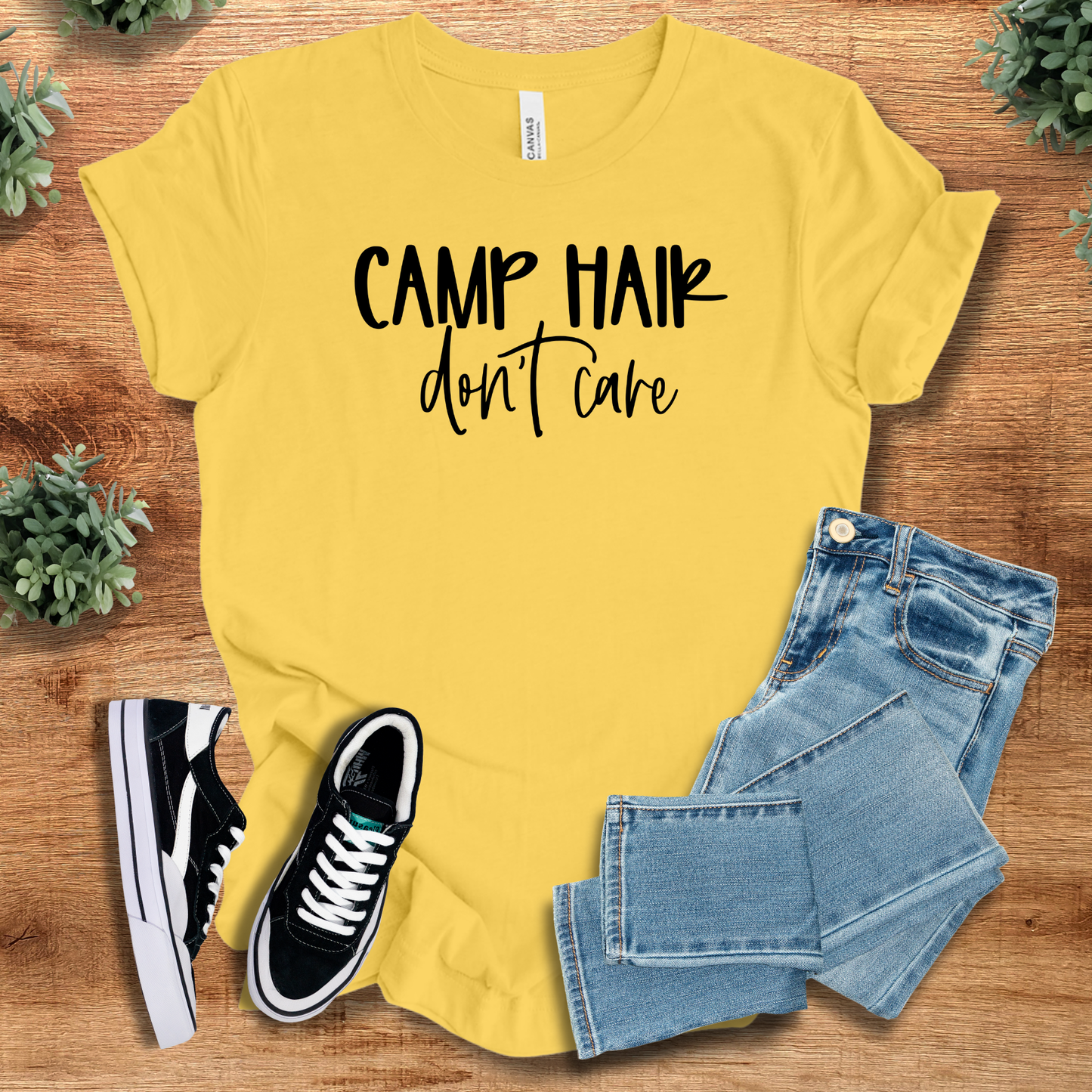 Athletic-heather t-shirt with '' text, flat lay styled on a wooden surface.