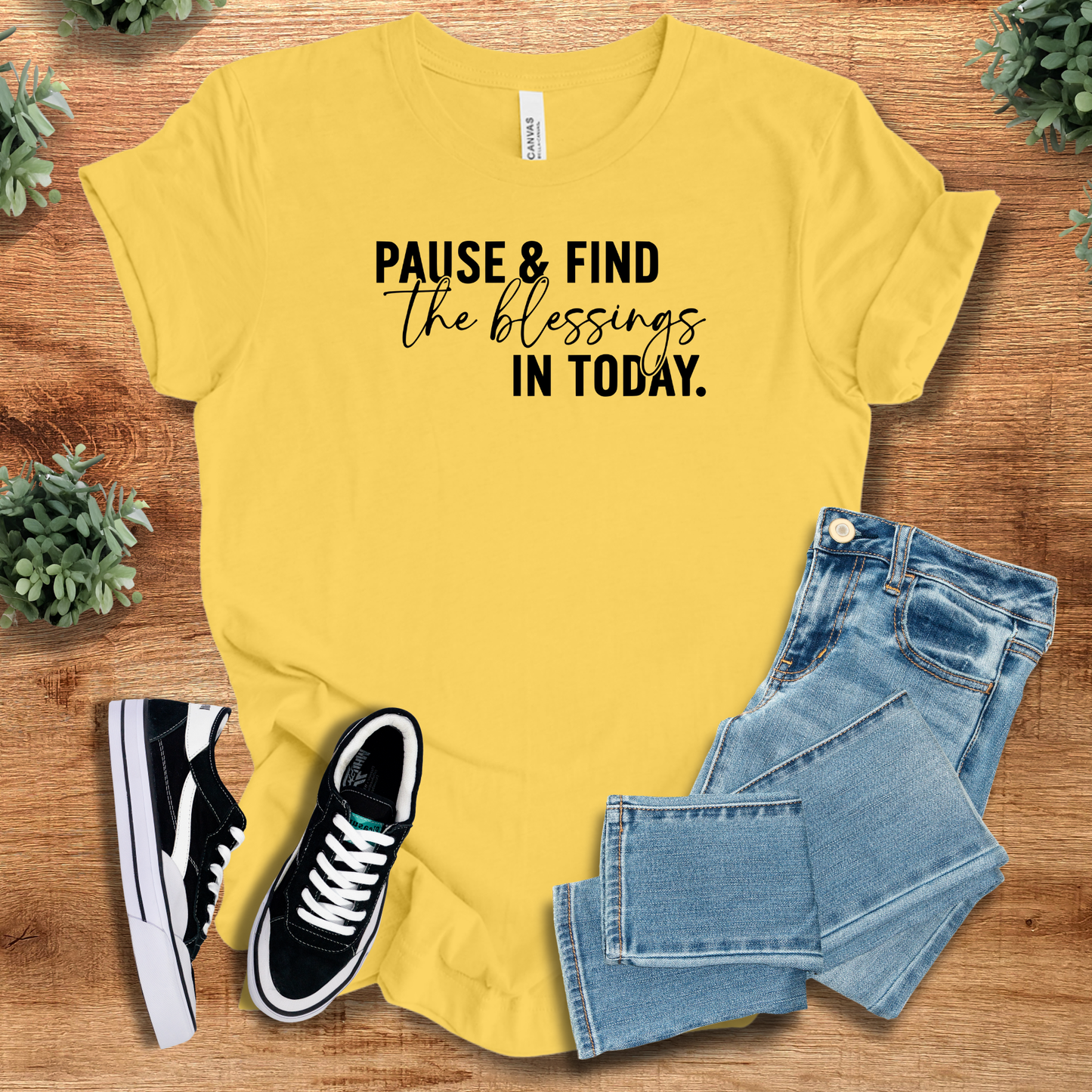 Athletic-heather t-shirt with '' text, flat lay styled on a wooden surface.