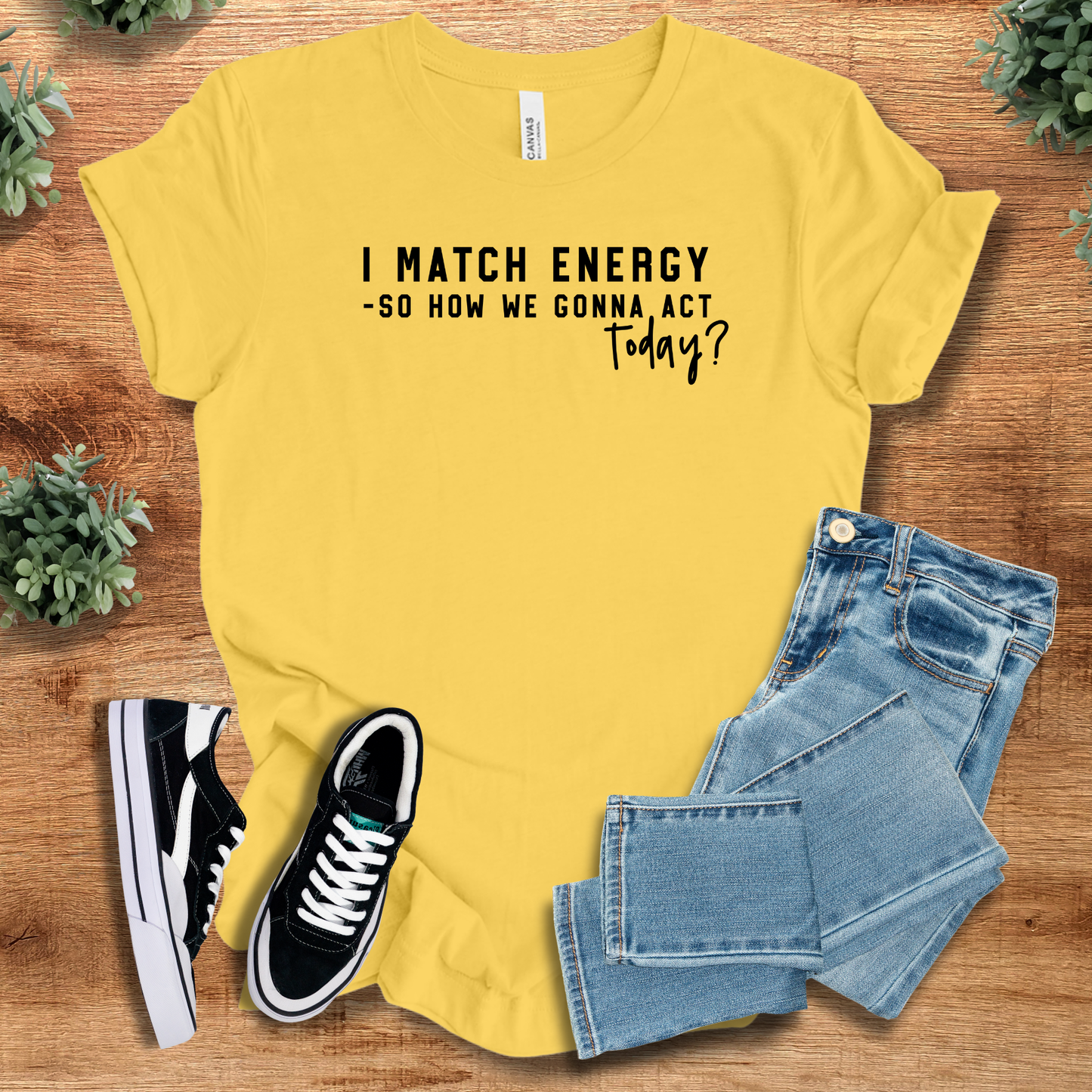 Athletic-heather t-shirt with '' text, flat lay styled on a wooden surface.