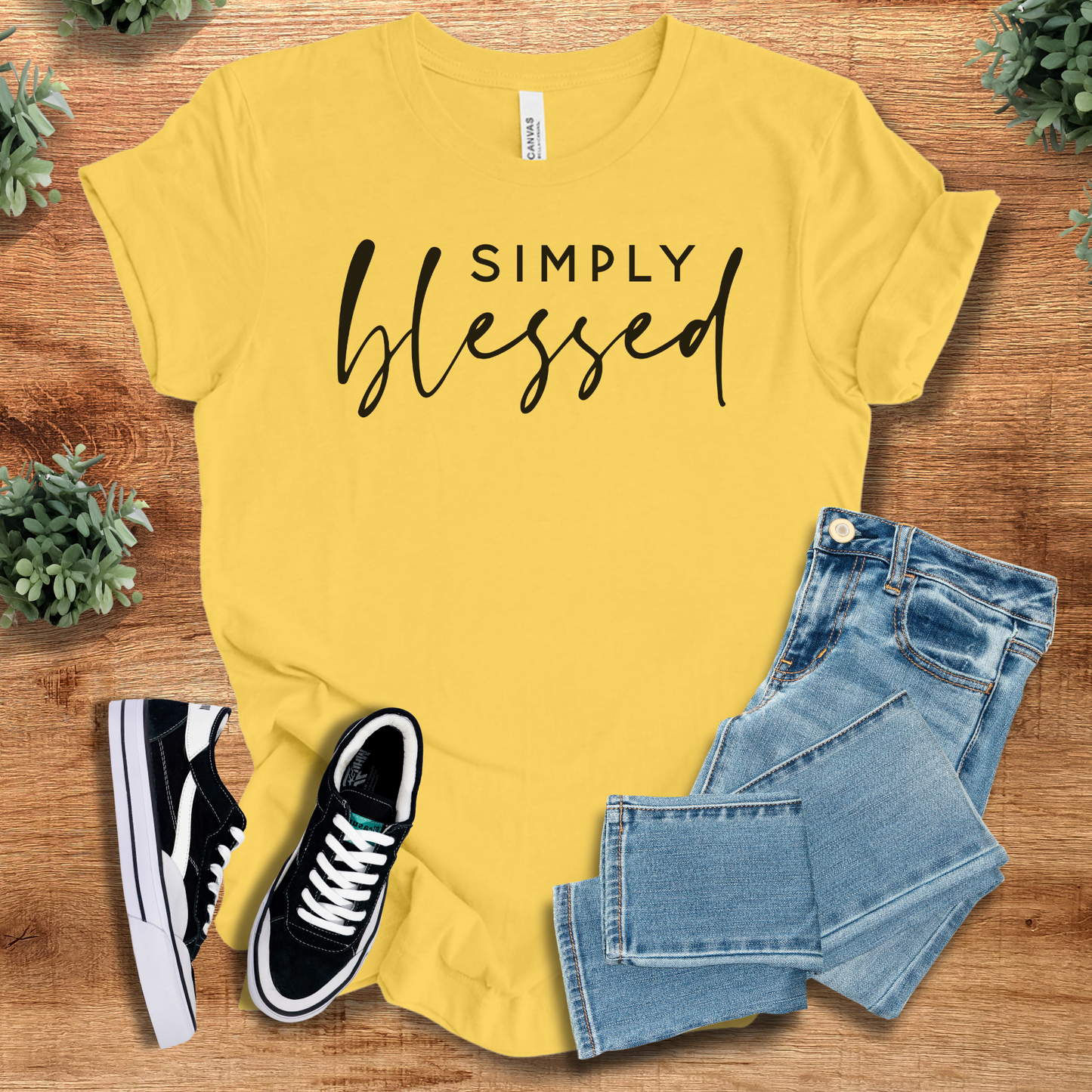 Athletic-heather t-shirt with '' text, flat lay styled on a wooden surface.