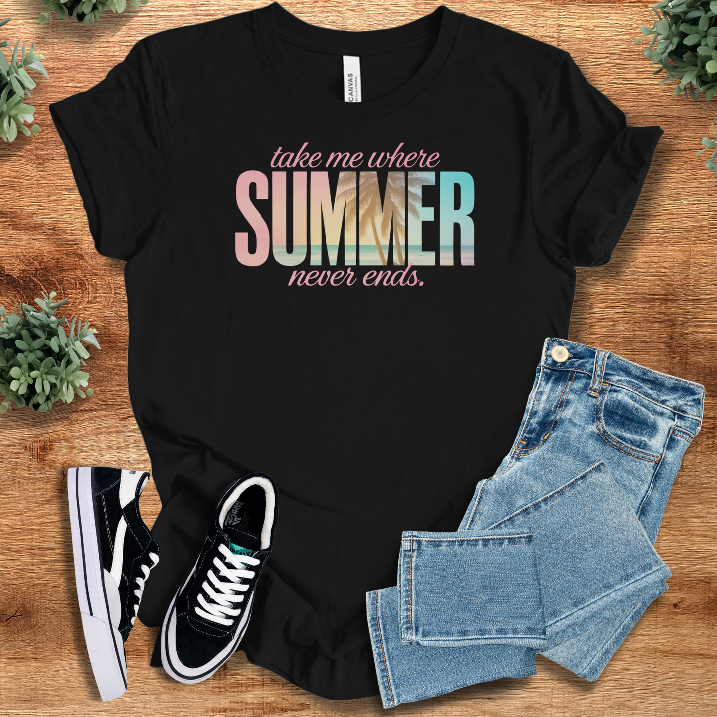 White t-shirt with '' text, flat lay styled on a wooden surface.