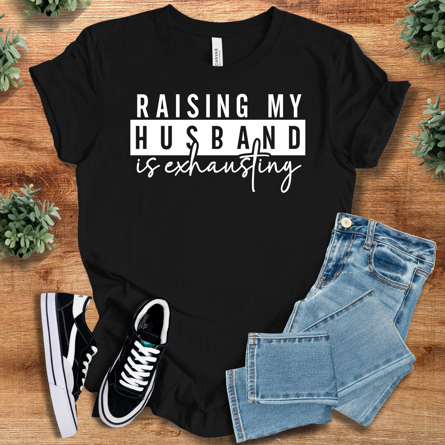 Heather-navy t-shirt with '' text, flat lay styled on a wooden surface.