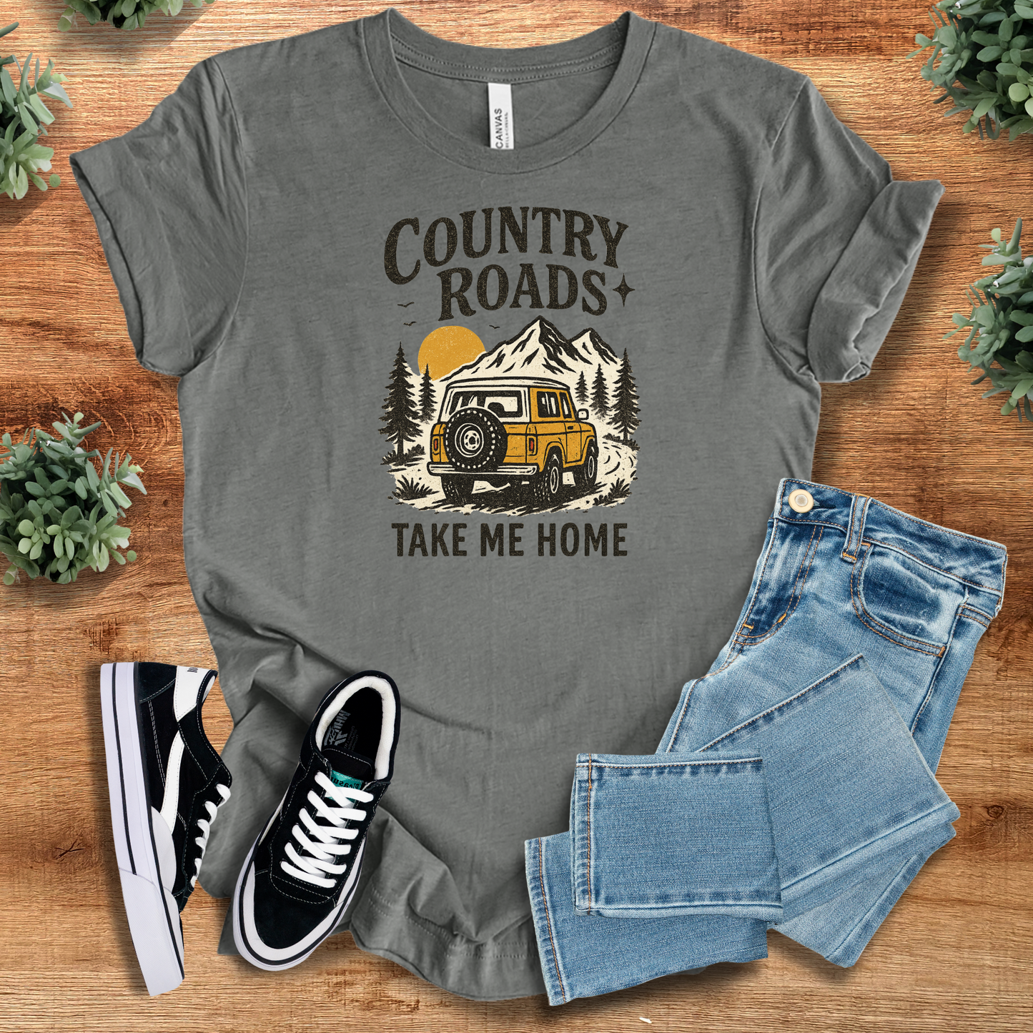 Heather-mauve t-shirt with '' text, flat lay styled on a wooden surface.