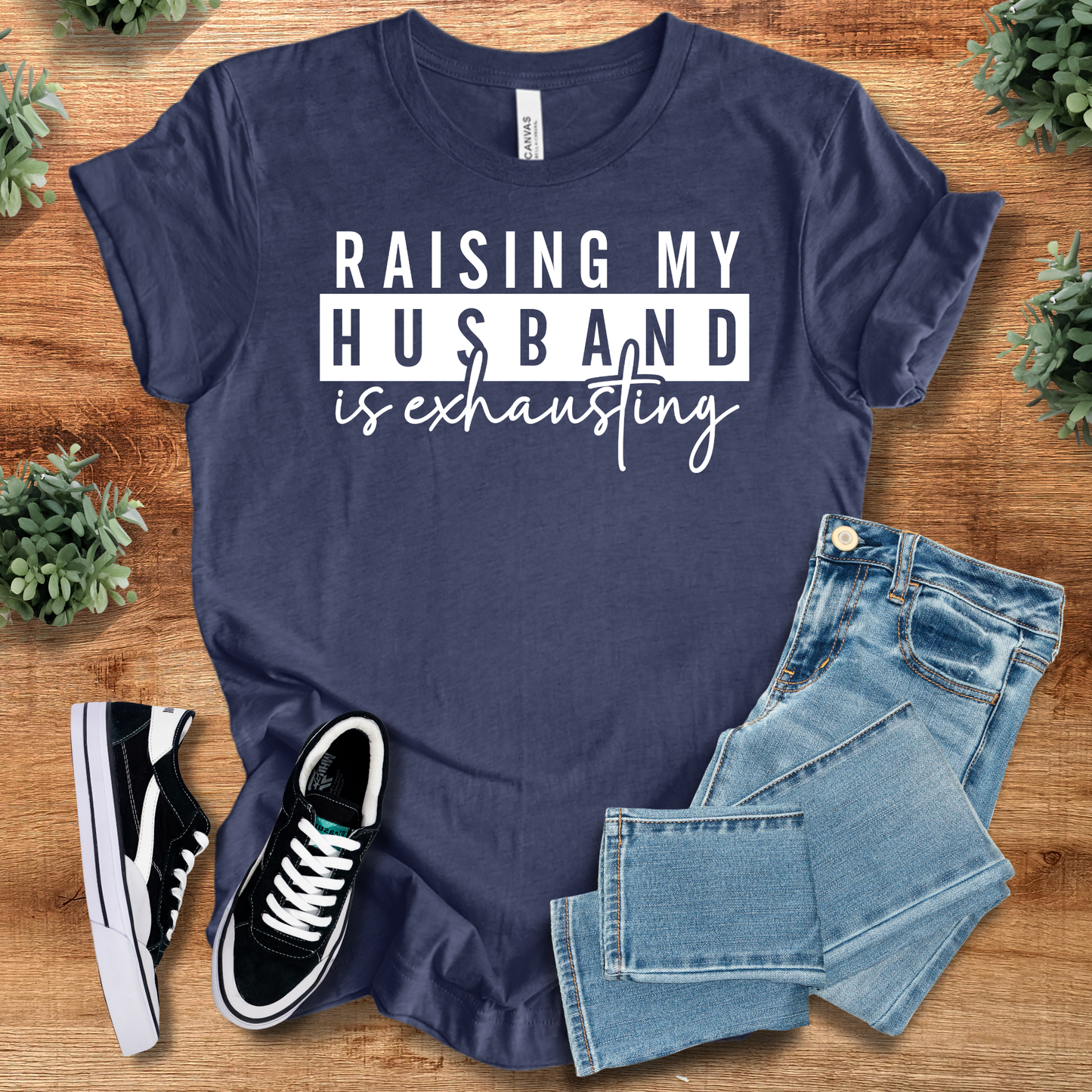 Athletic-heather t-shirt with '' text, flat lay styled on a wooden surface.