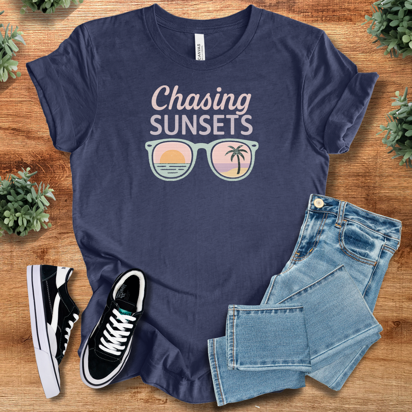 Sunset T-Shirt for Summer in navy blue with 'Chasing Sunsets' text and sunglasses graphic. Lightweight cotton tee ideal for beach and travel wear.