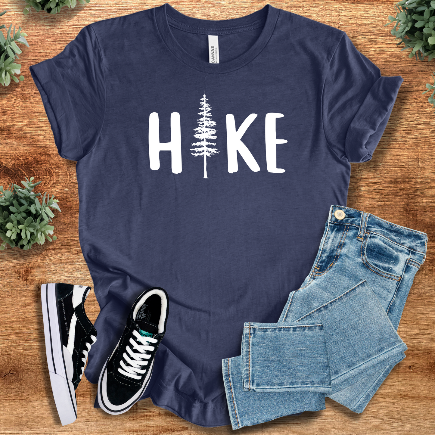 Hike T‑Shirt in navy blue Bella+Canvas 3001 with white tree graphic. Nature-inspired unisex tee with minimalist outdoor design.
