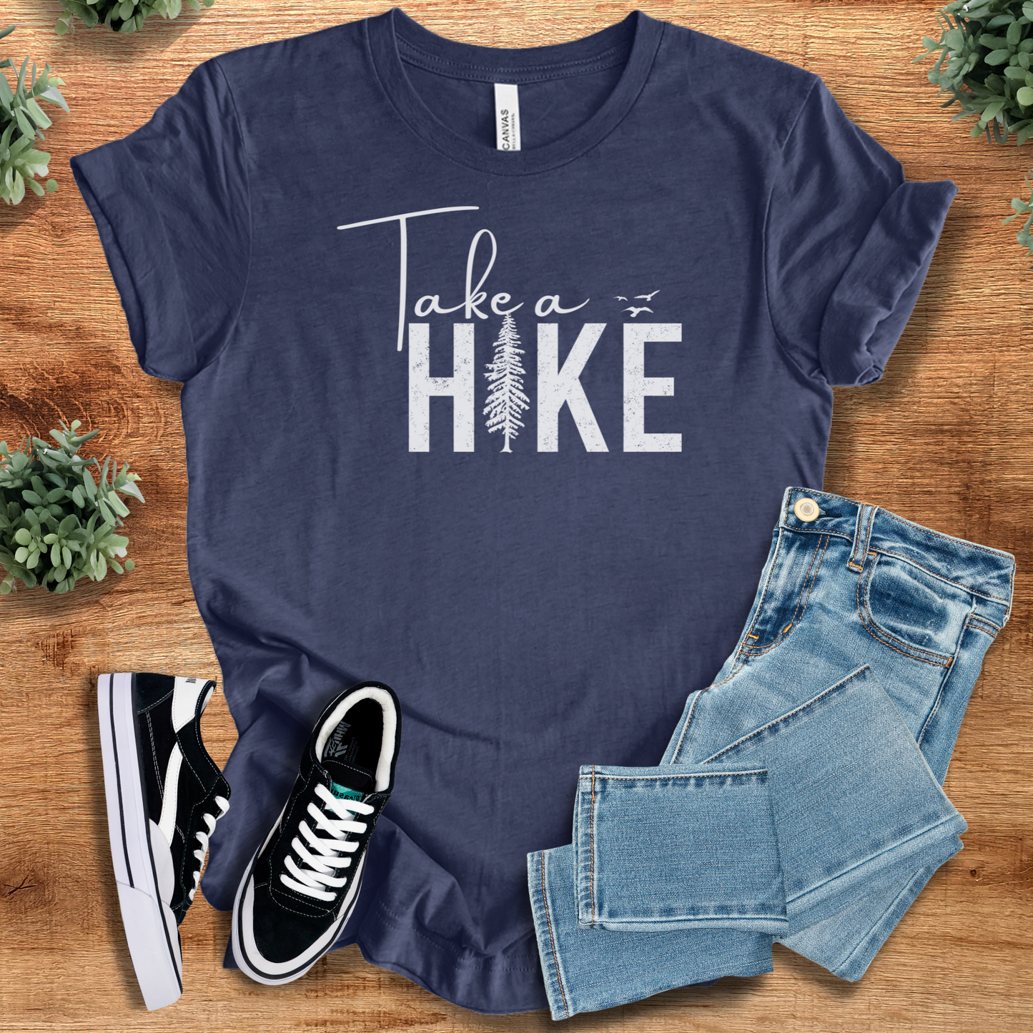 Soft-cream t-shirt with '' text, flat lay styled on a wooden surface.